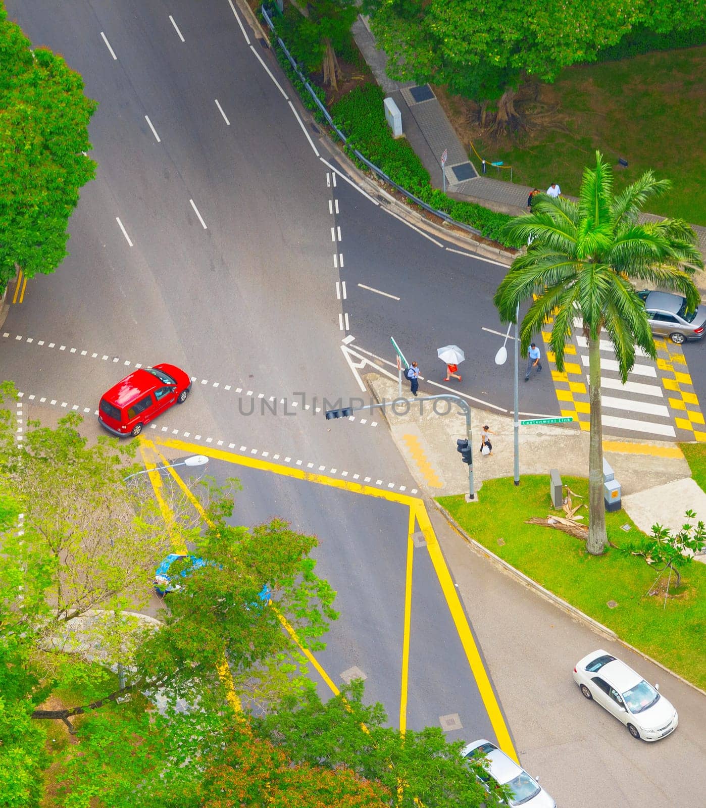 Aerial view of road traffic in Singapore. People crossing the road