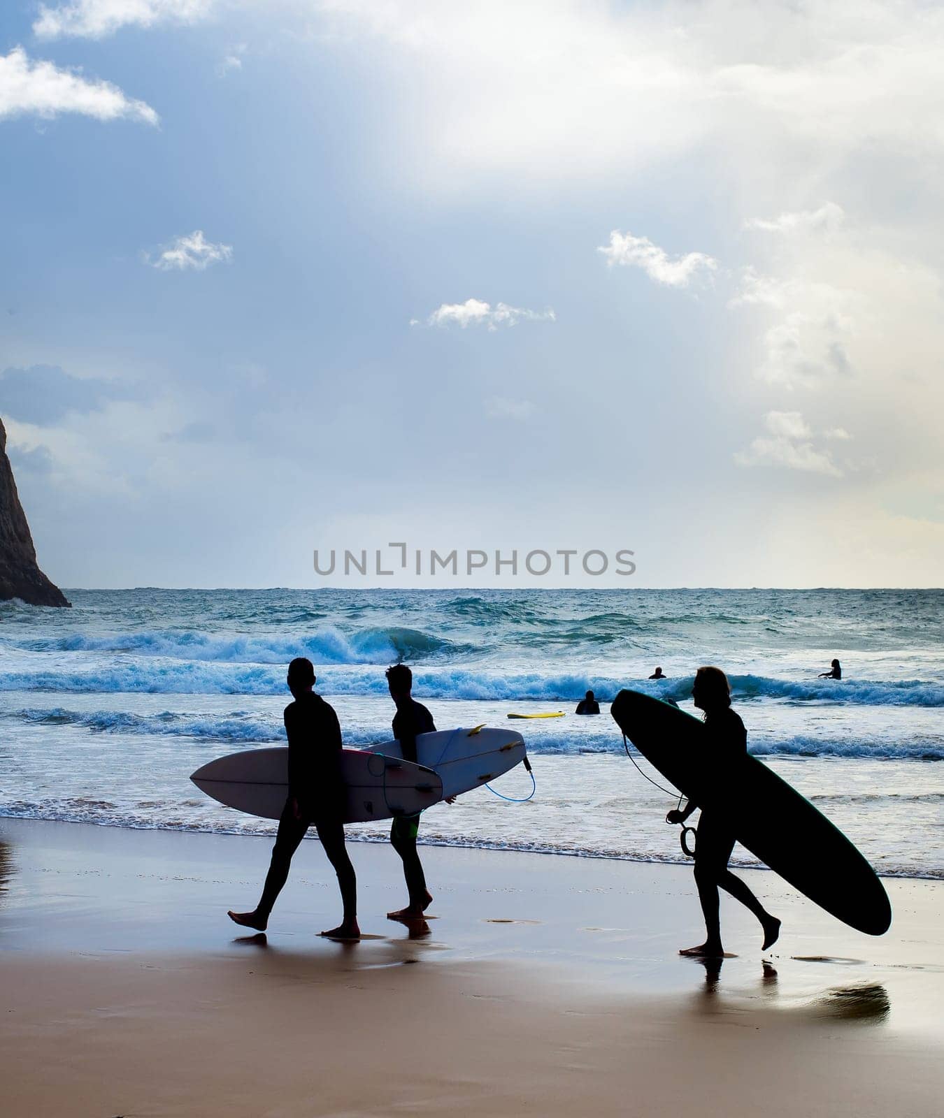 Group of surfers with surfboards on the beach. Algarve, Portugal