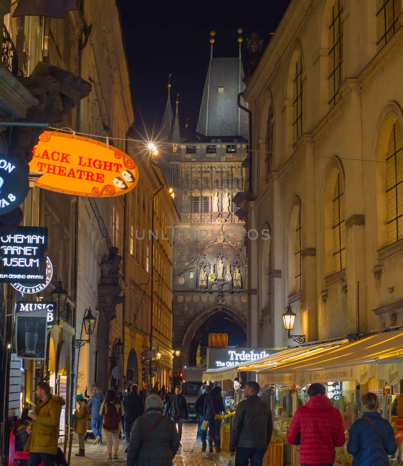 RRAGUE, CZECH REPUBLIC - NOVEMBER 13, 2018: Peope walking by Old Town street of Prague heading to Charles Bridge.
