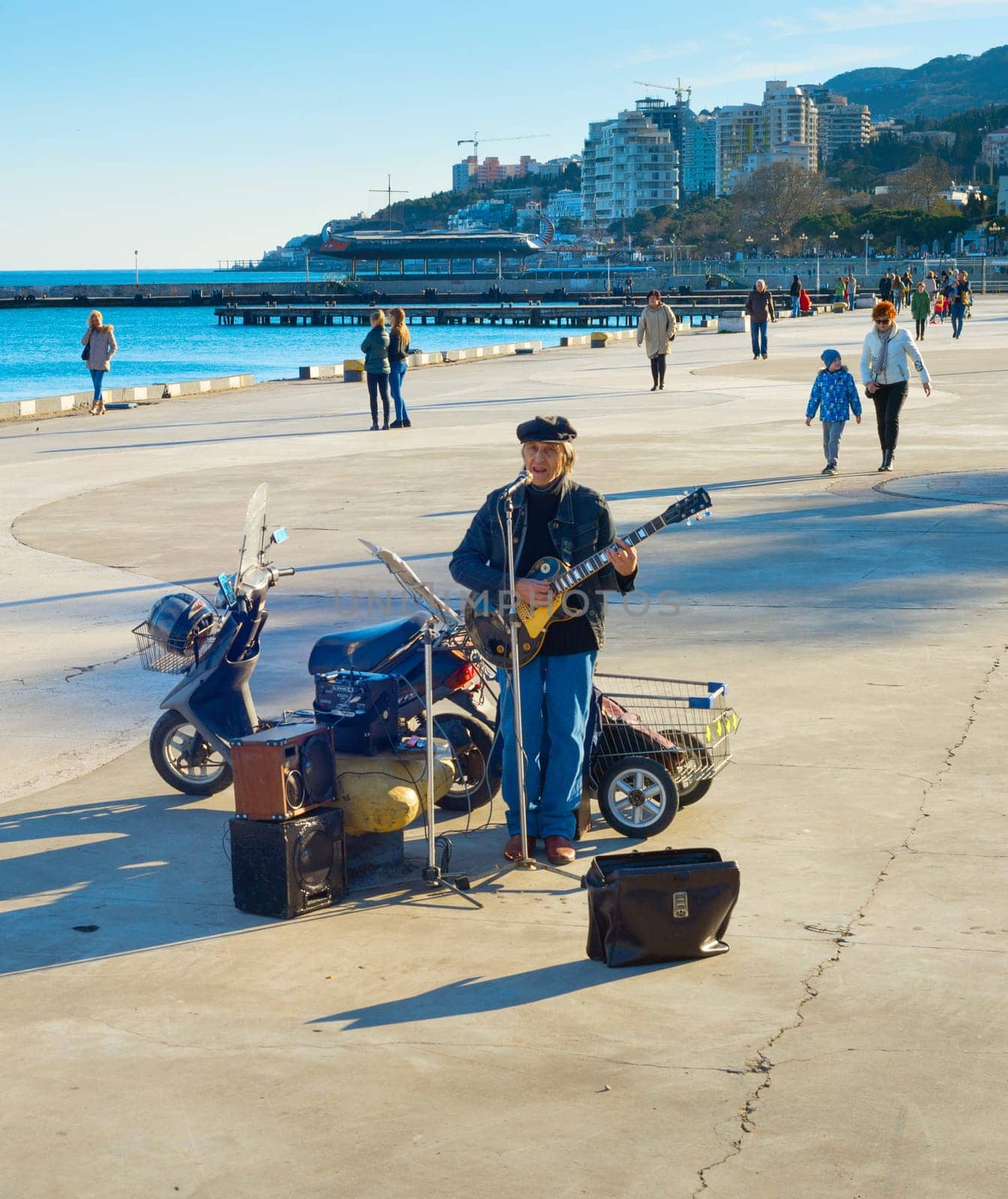 YALTA, CRIMEA, UKRAINE - APRIL 03, 2018: Street musician at Yalta promenade in sunny day. Yalta is the most famous tourist destination in Crimea