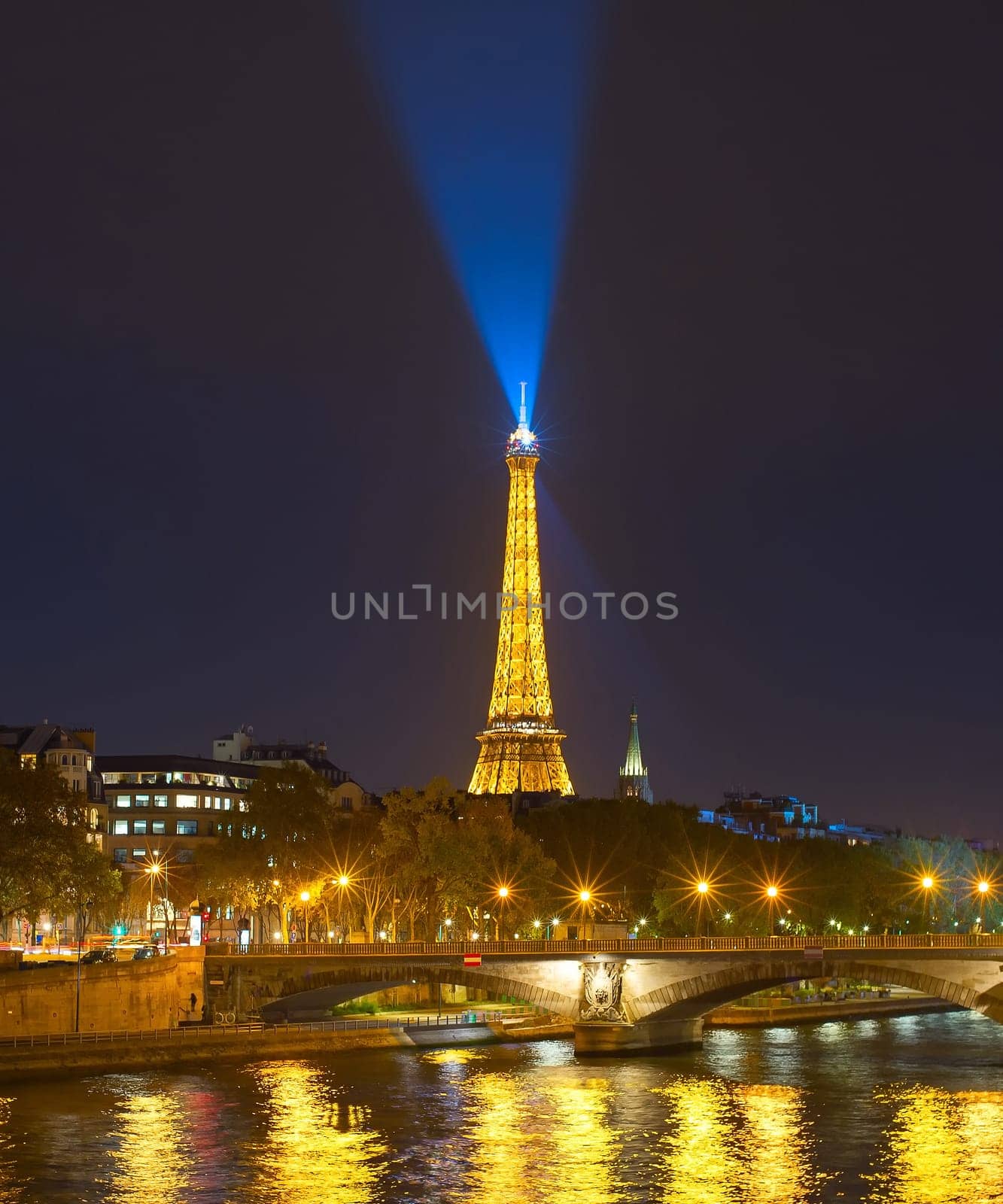 PARIS, FRANCE - OVEMBER 10, 2018: Siene river embankment and Eiffel Tower with spotlight at night in Paris.