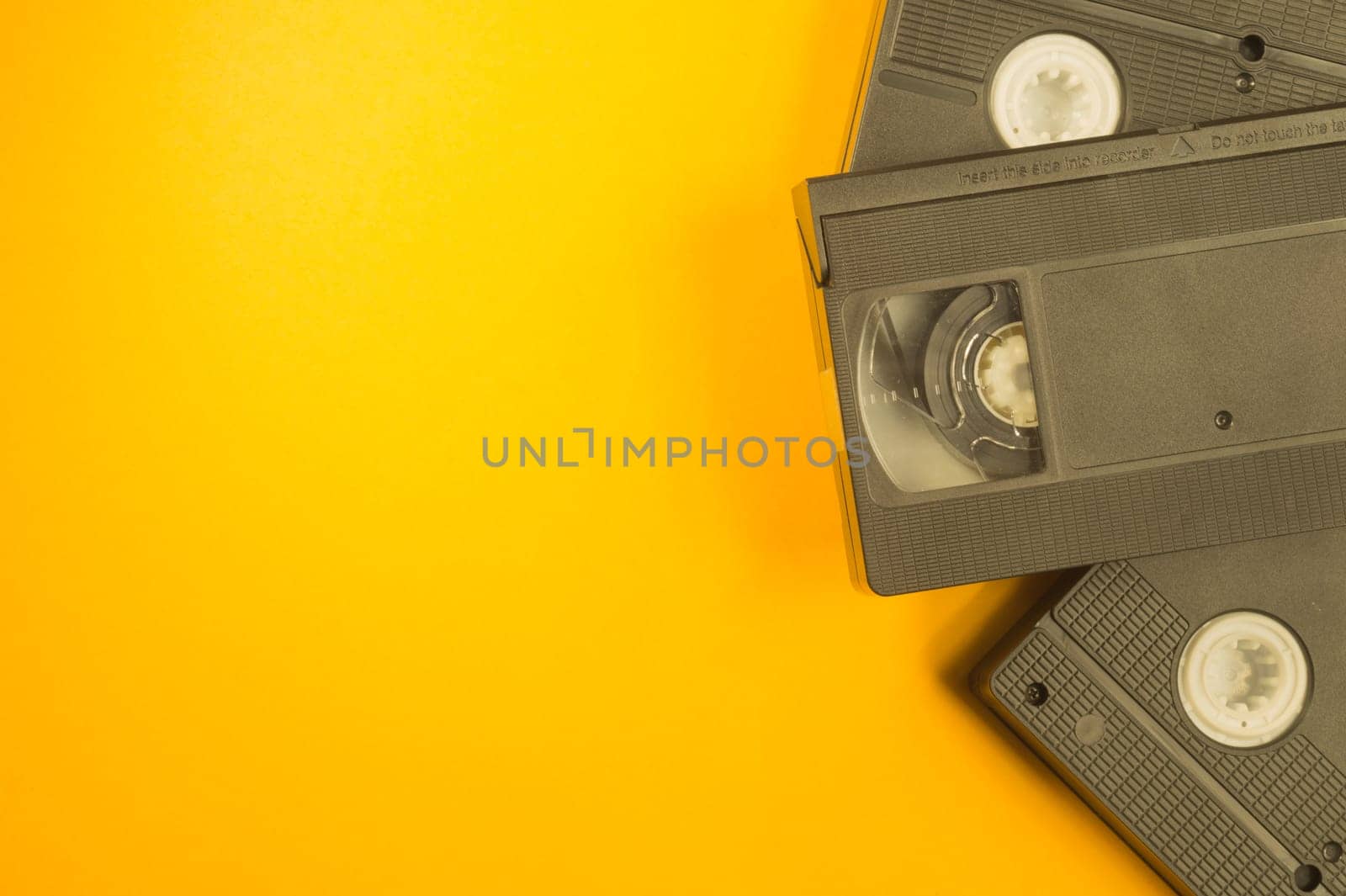 Video cassette isolated on yellow background. vhs with copy space