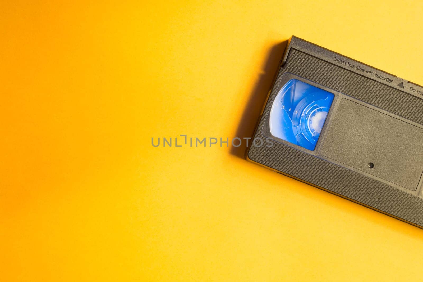Video cassette isolated on yellow background. vhs with copy space