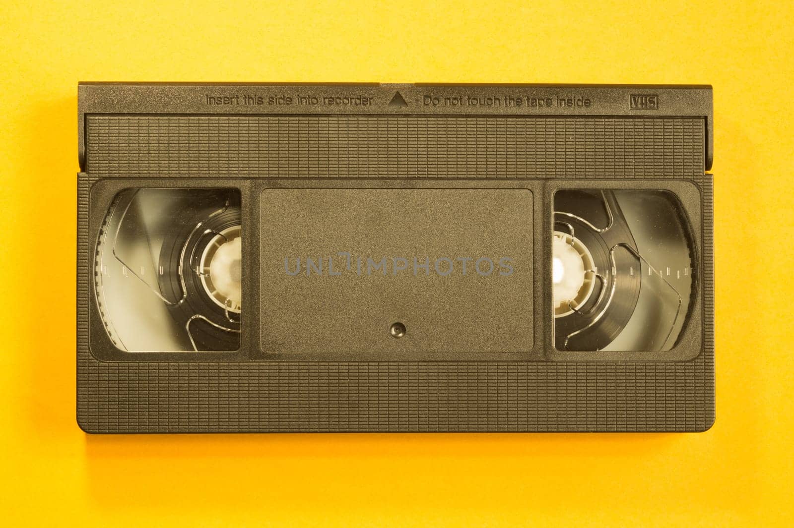 Video cassette isolated on yellow background. vhs with copy space