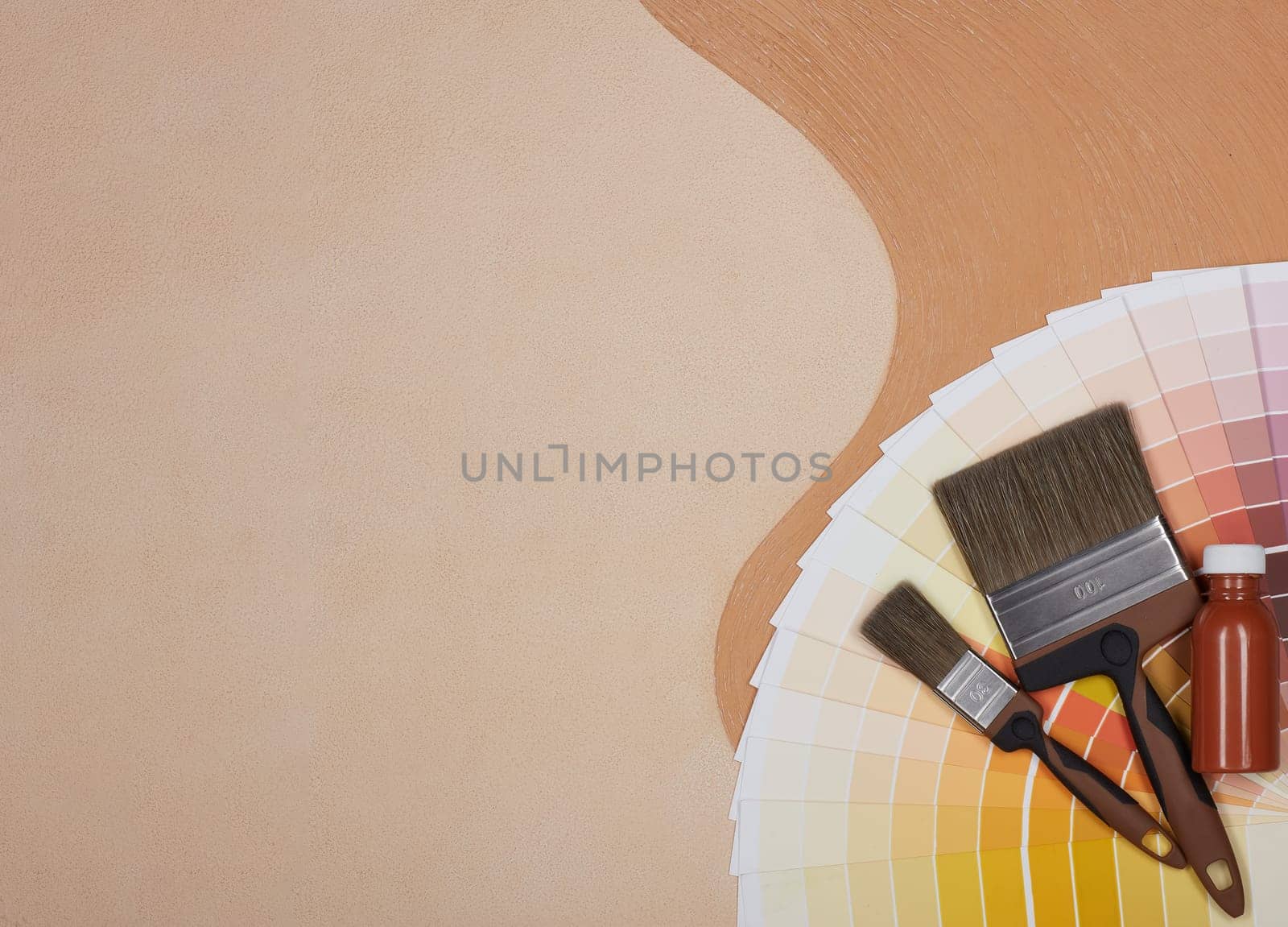 Color palette guide, paint brushes and bottle of paint lying on textural double background consisting of two beige shades. Top view with copy space, Concept of construction or design office