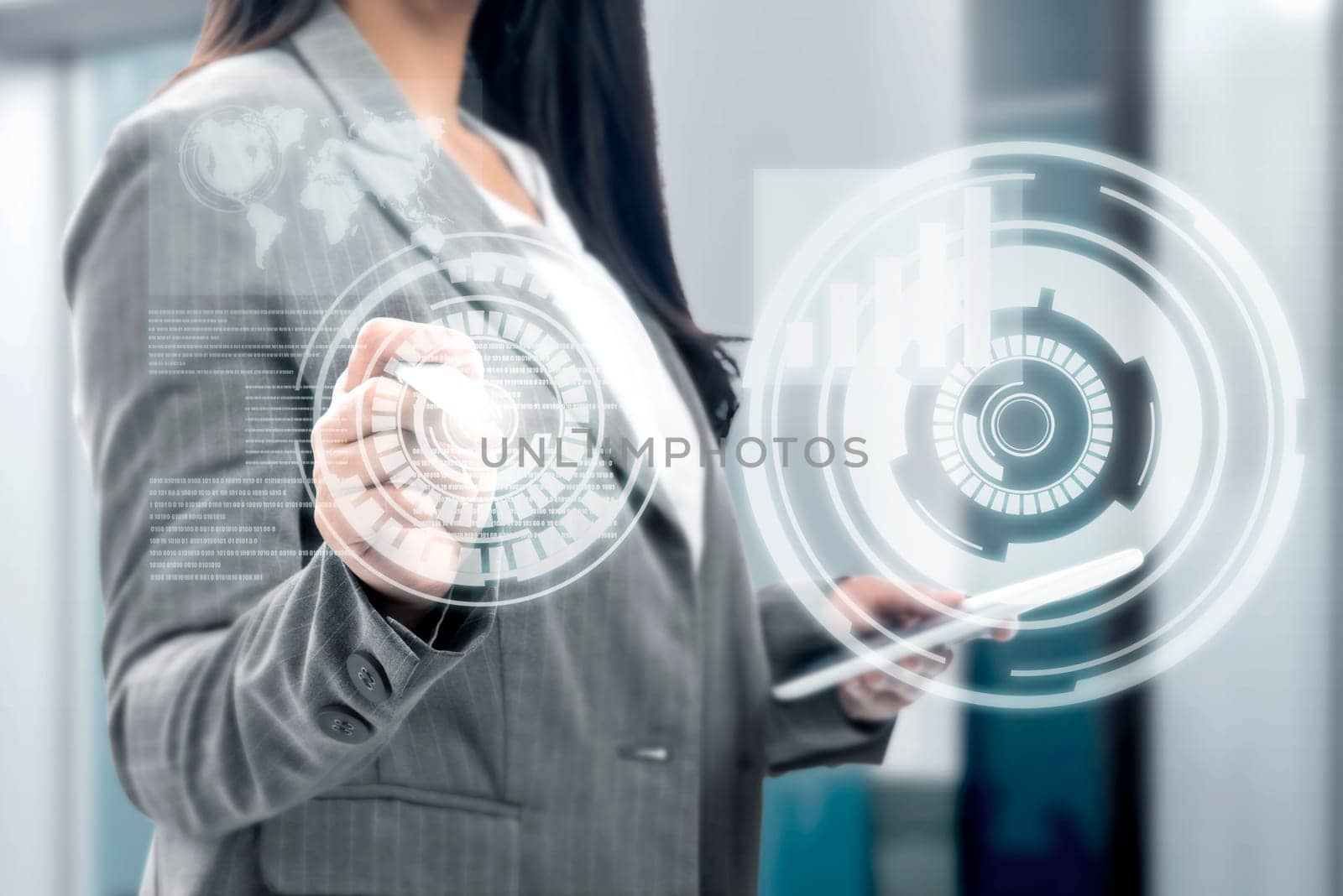 Business woman holding digital tablet and drawing with marker on virtual screen which display the interface of financial chart and world maps. Digital technology concept