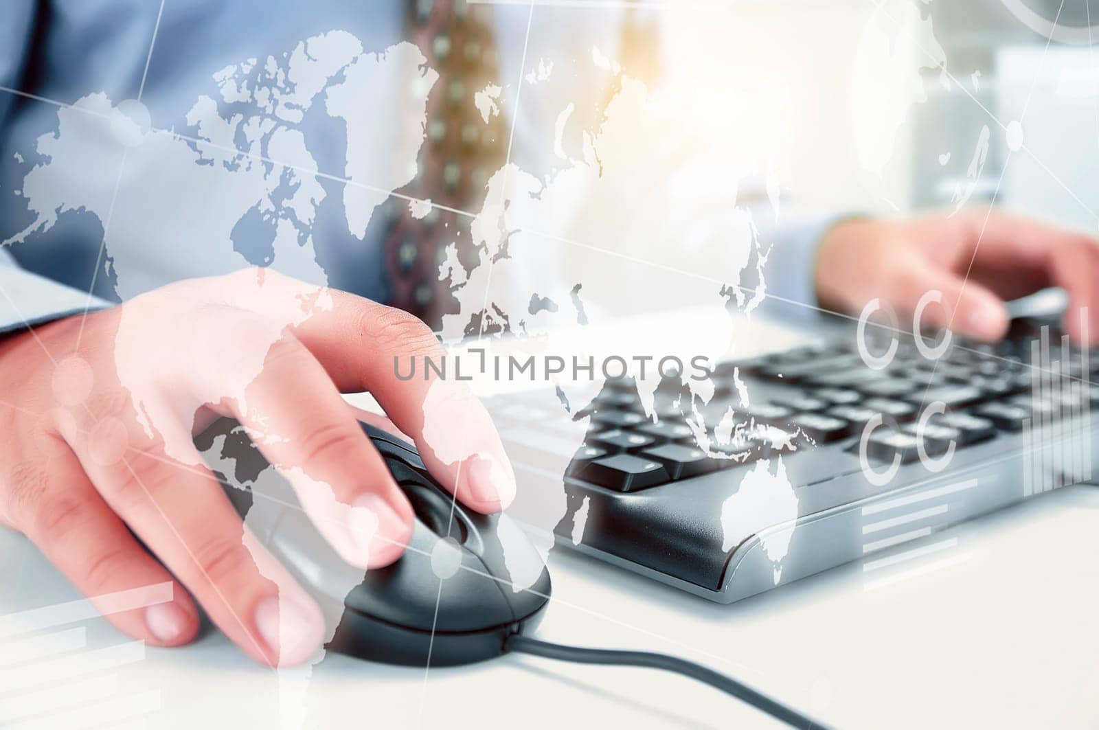 Businessman working with keyboard and mouse on the desk with display interface of world map, chart and graphs. Digital technology concept