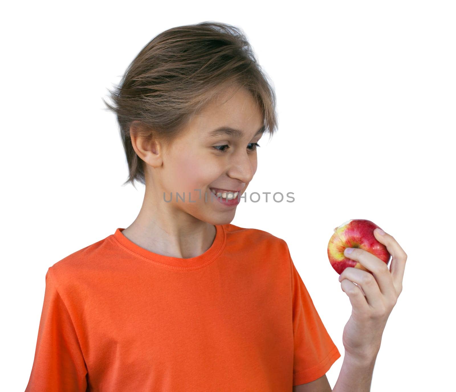 Portrait casual young man eating apple, against a white wall
