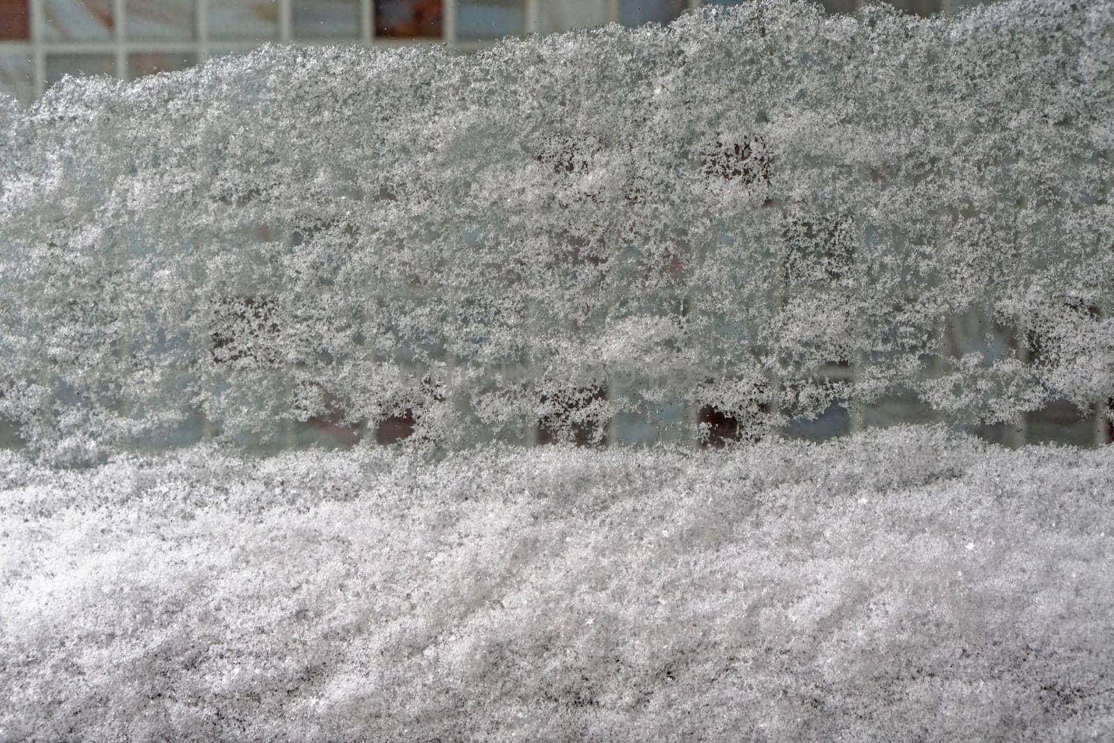 Big snow cover at window in winter
