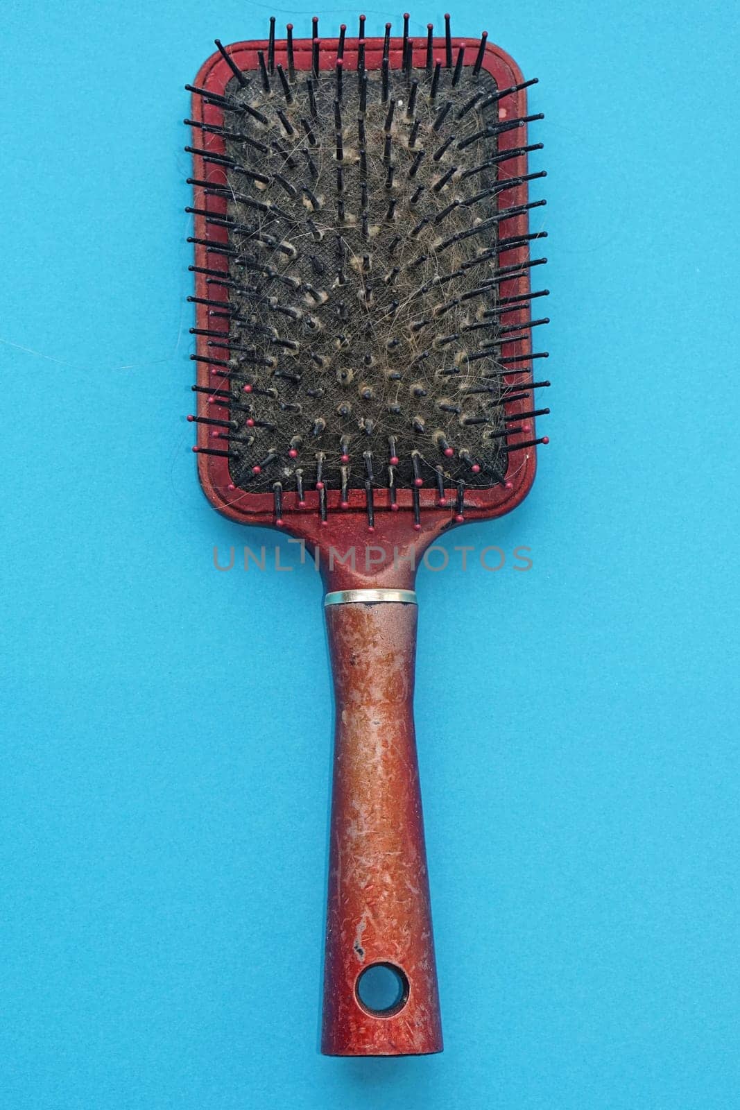 One old used hairbrush with lot of hair