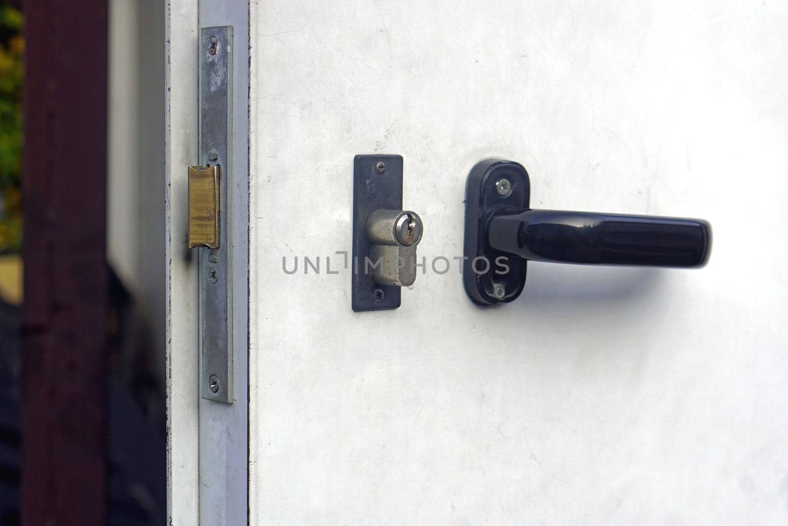 Black handle with lock at metal door