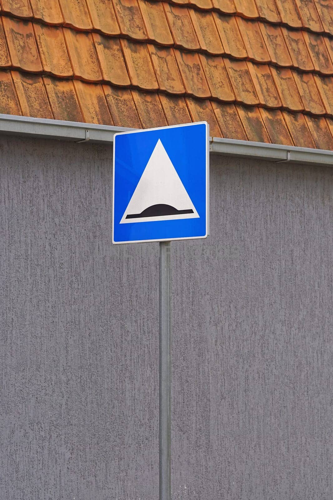 Speed bump road traffic sign at pole