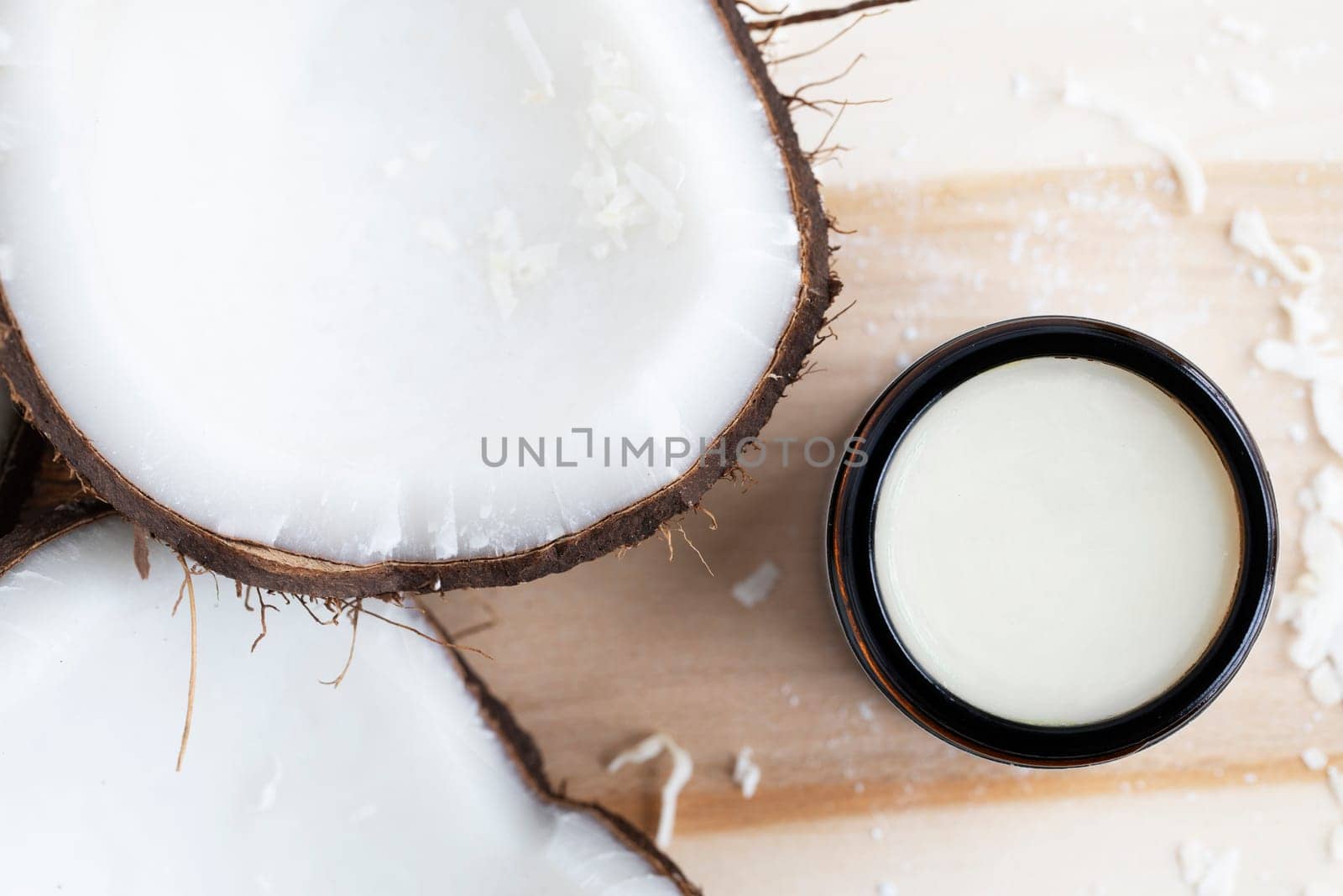Coconuts with coconut cosmetic cream from a top down view.