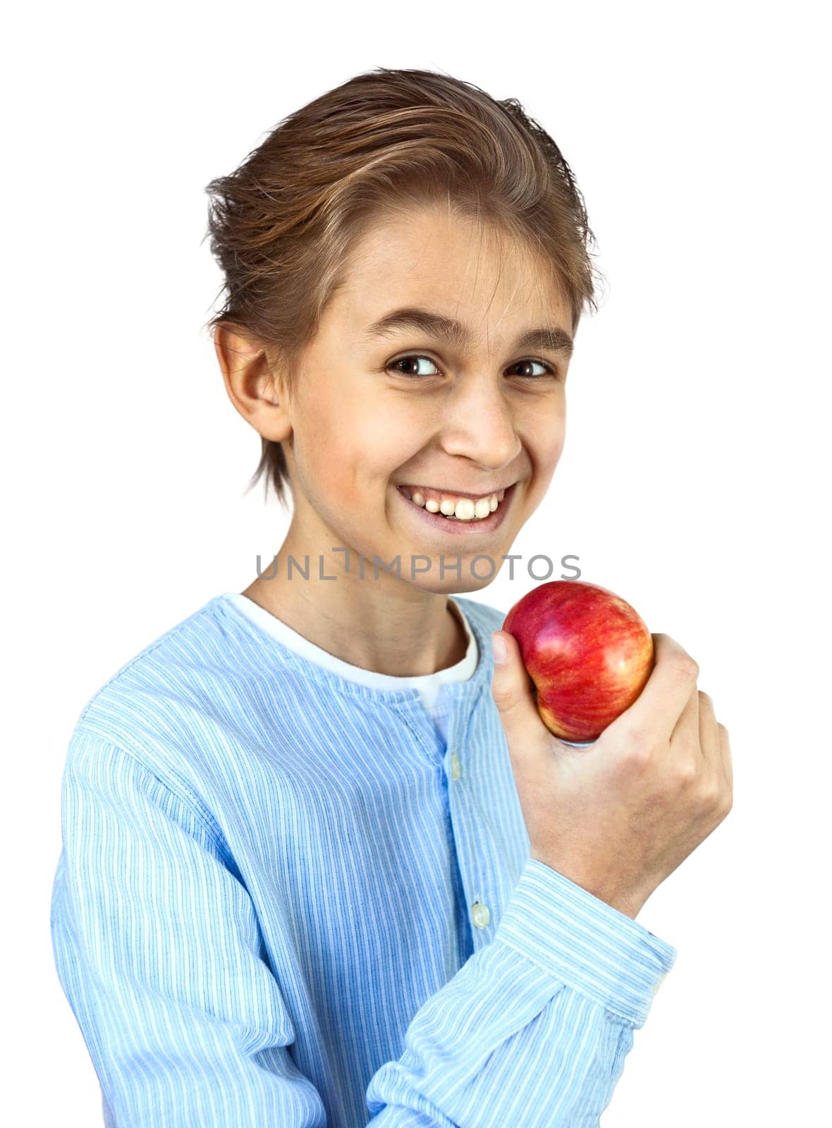 Young boy eating red apple. On a white background.