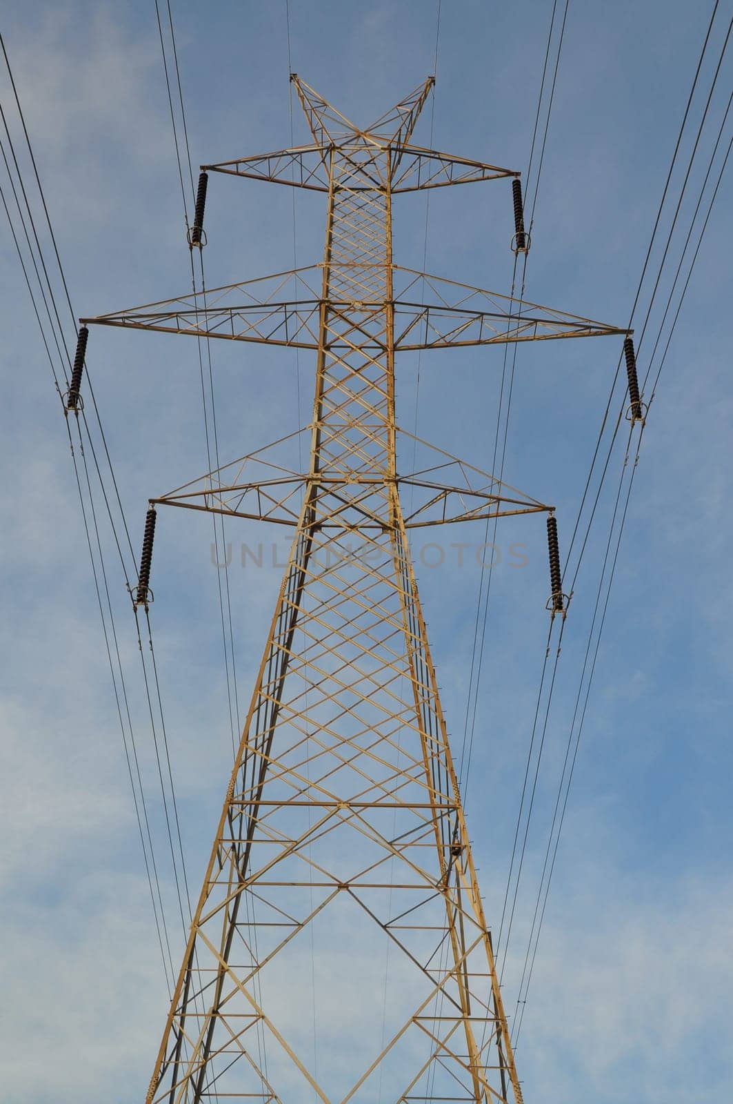 Transmission tower electricity pylon steel industrial structure and power lines.
