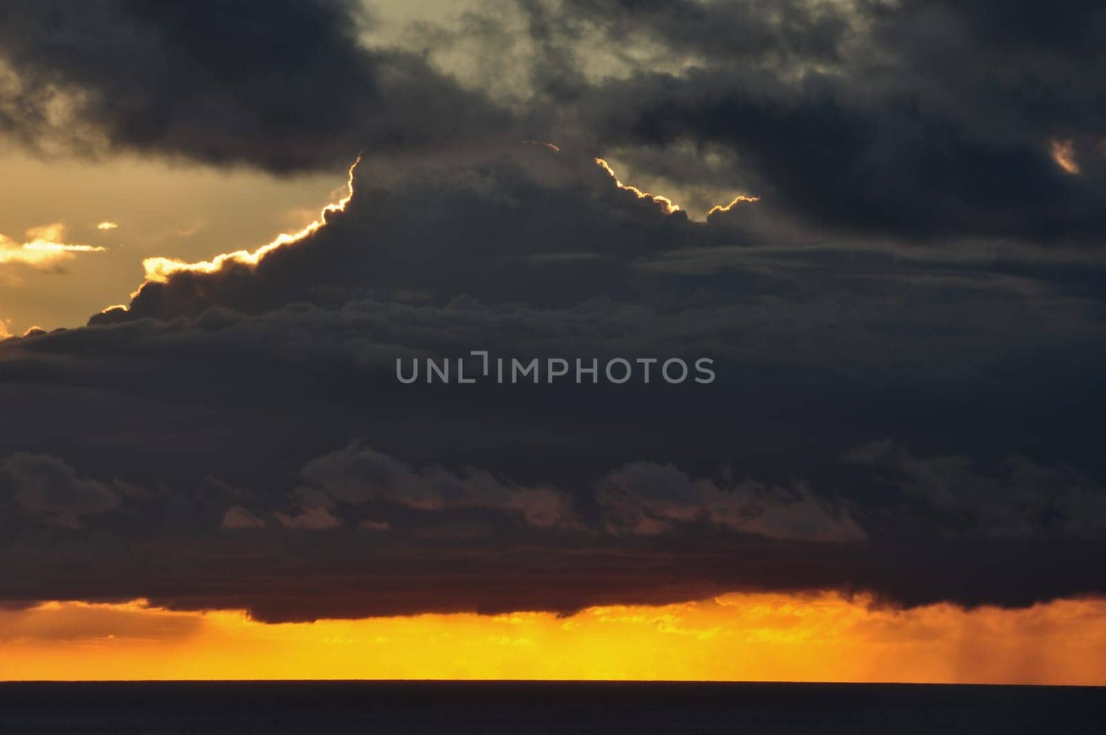 Cloudy sunset sky and sea horizon. Abstract nature background.