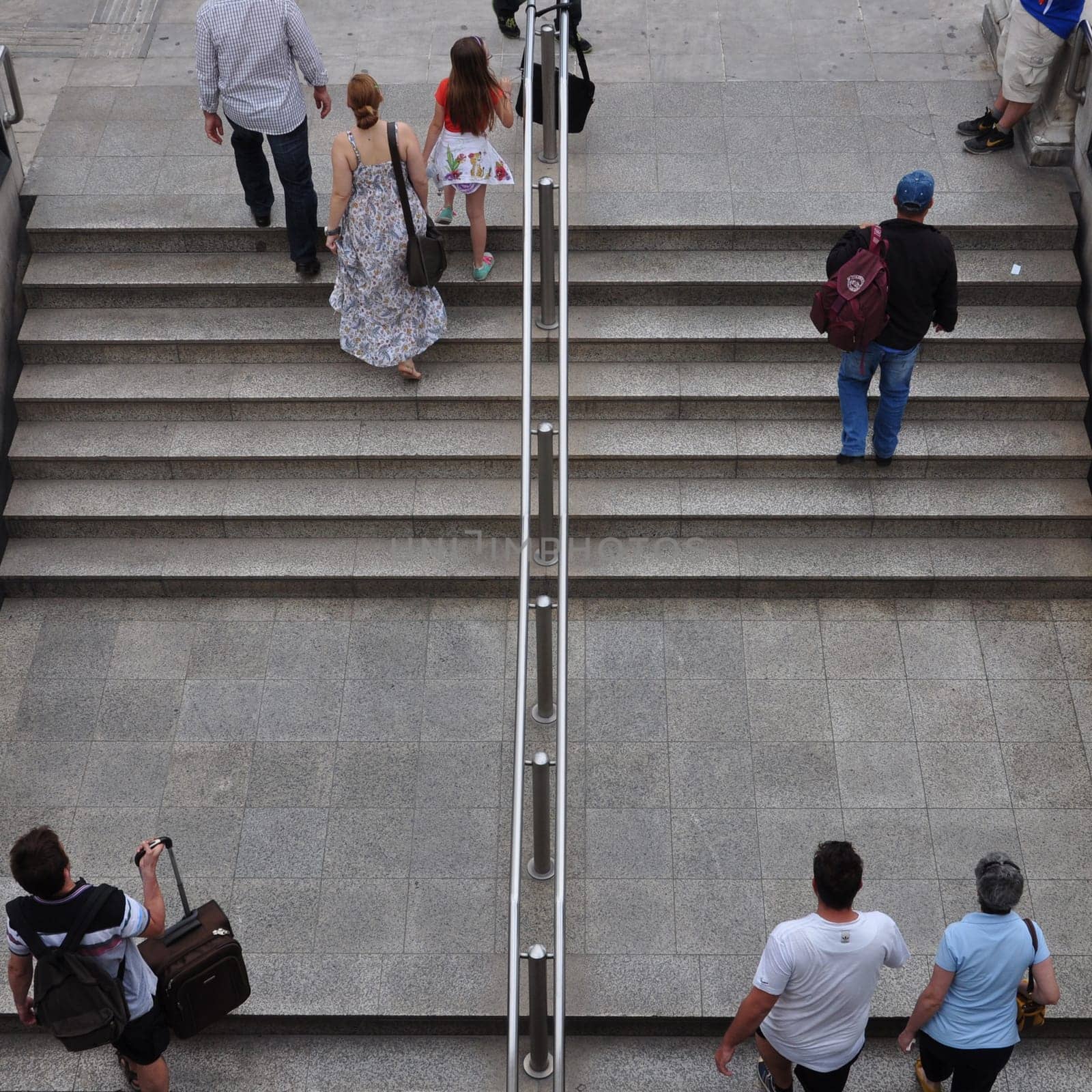 ATHENS, GREECE - JUNE 9, 2014: People walking up the stairs of Syntagma metro station. Daily life street scene in downtown Athens, Greece.