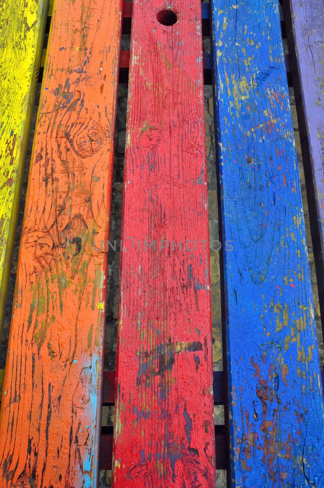 Wood background planks painted with vivid colors. Abstract texture.