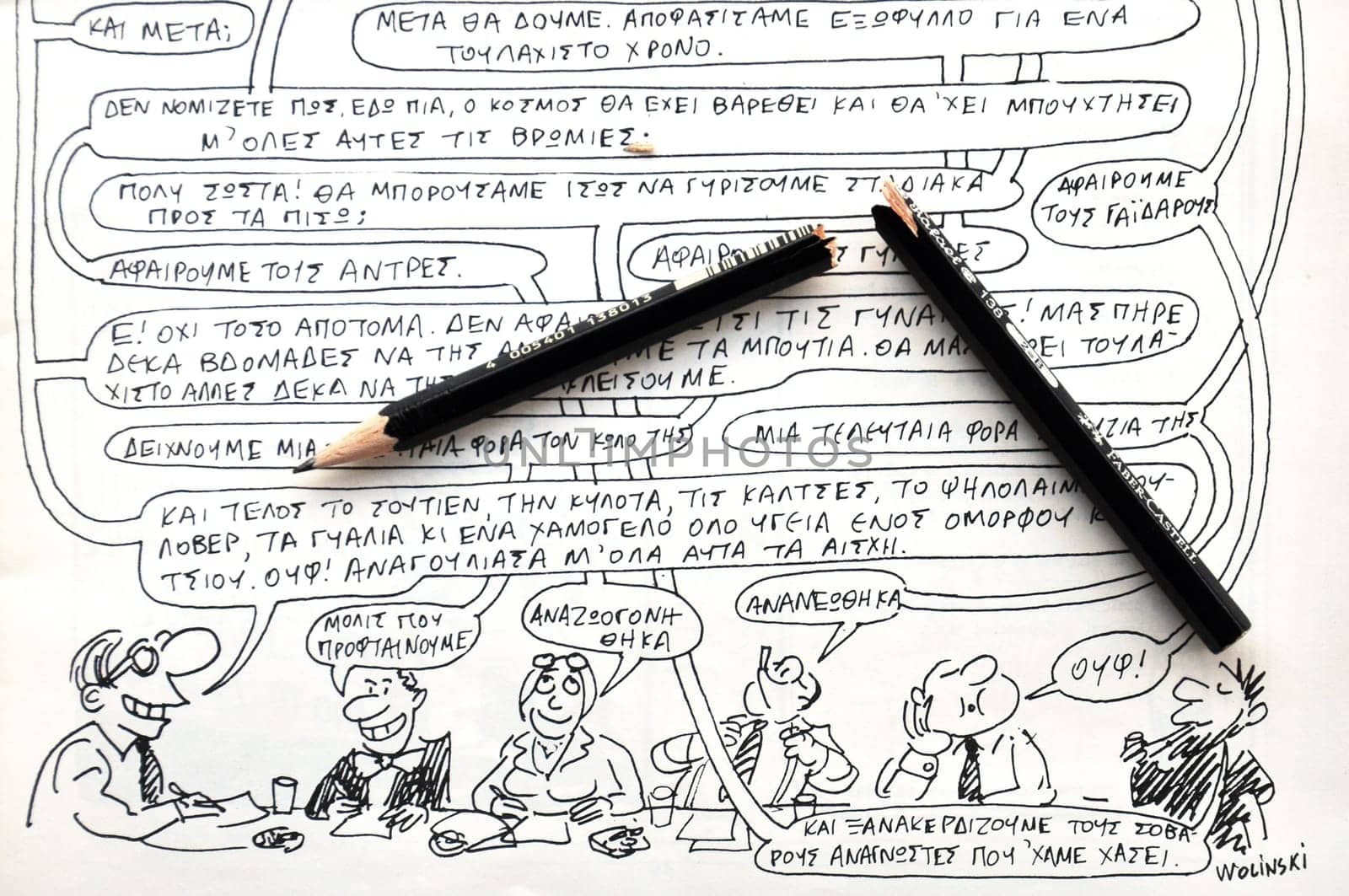 ATHENS, GREECE - JANUARY 8, 2015: Broken pencil and comics by cartoonist and writer Georges Wolinski (1934 - 2015) victim of the terrorist attack at Charlie Hebdo satirical newspaper on January 7, 2015 in Paris, France.