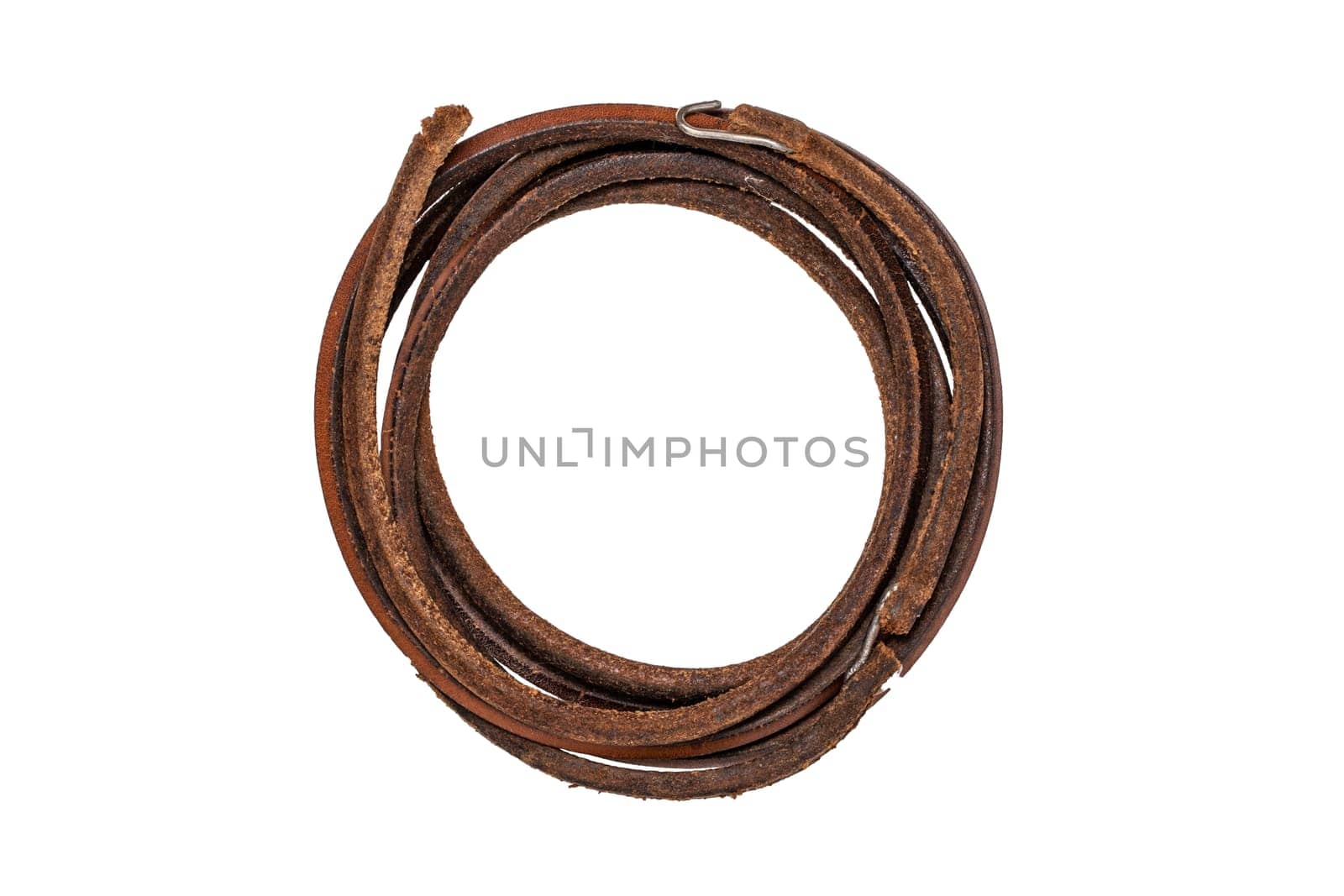 Tailoring accessories. Macro of a old leather fan belt or drive belt for a foot operated mechanical sewing machine isolated on white.