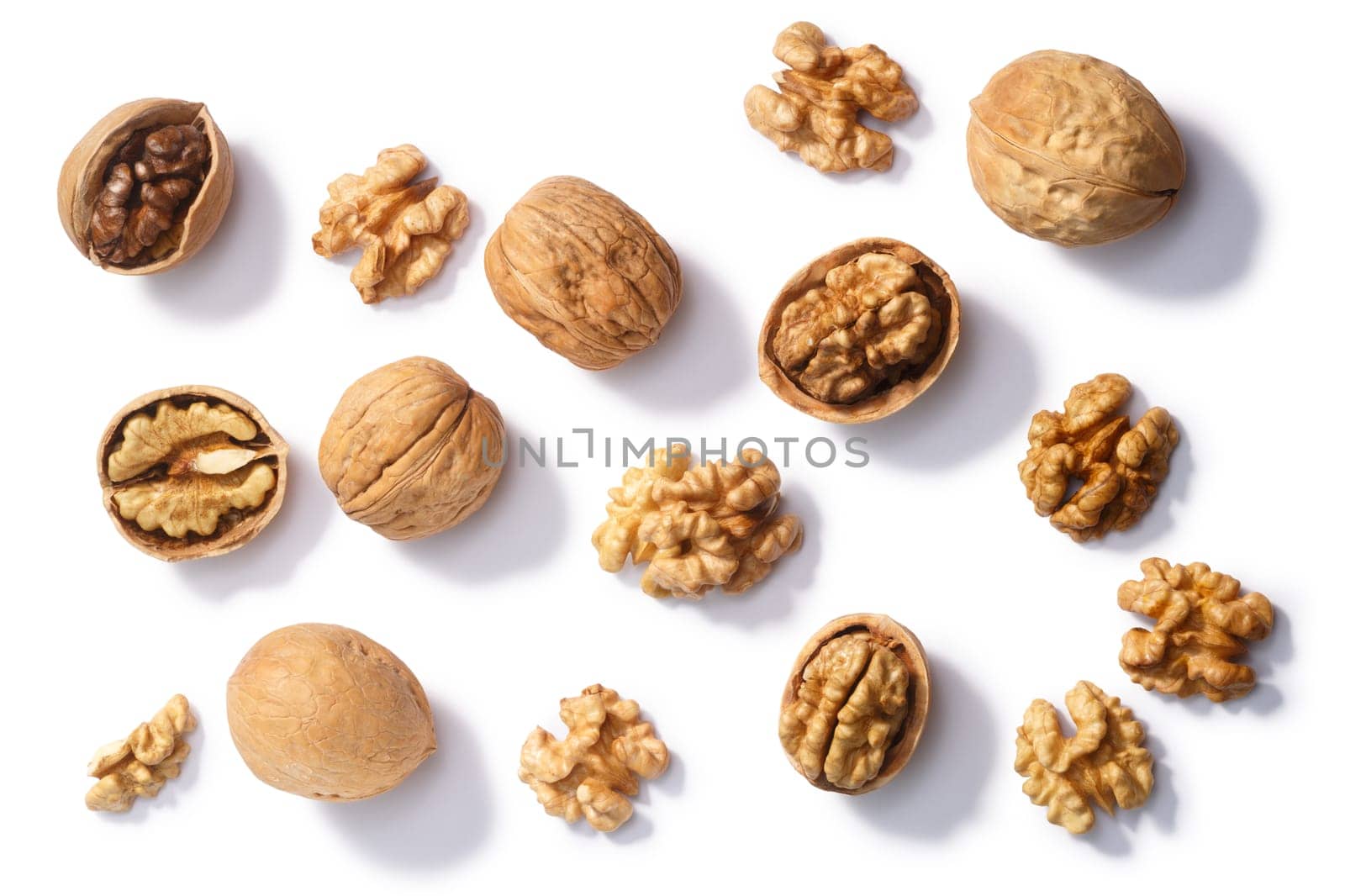 Walnuts (Juglans regia seeds), whole, shelled, halves and partially cracked, top view