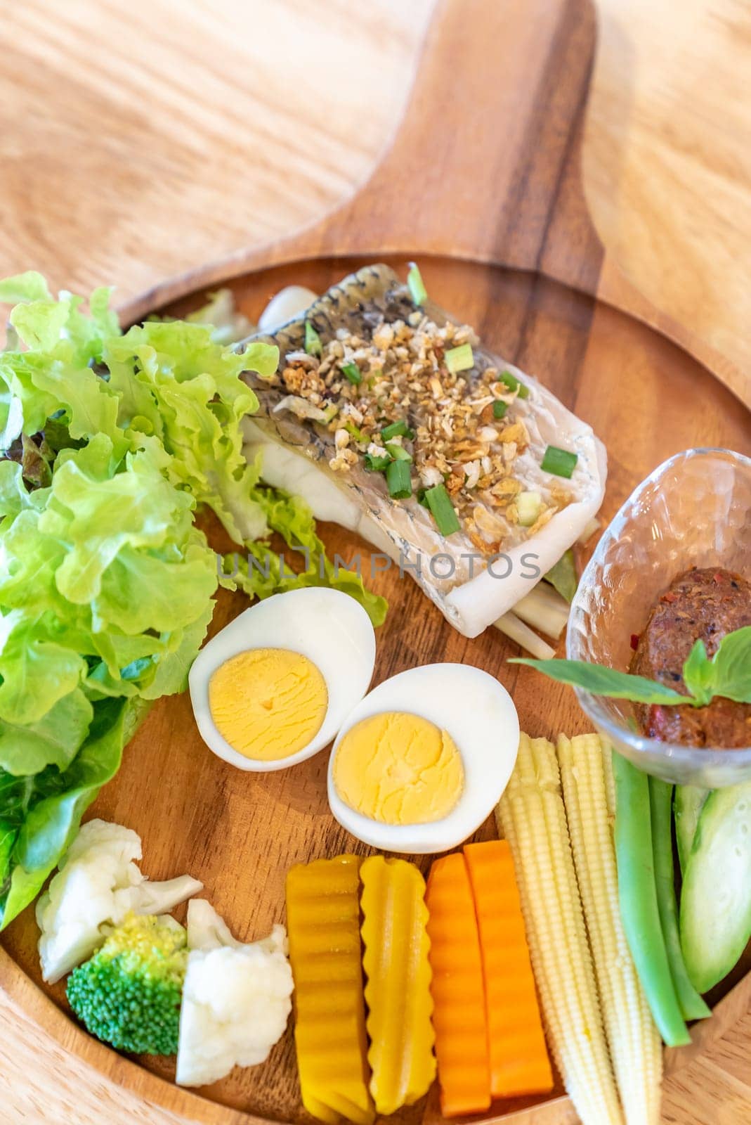 grilled sea bass with Galangal Nam phrik organic chili paste with variety organic vegetable and egg.  Thai traditional healthy food cuisine.