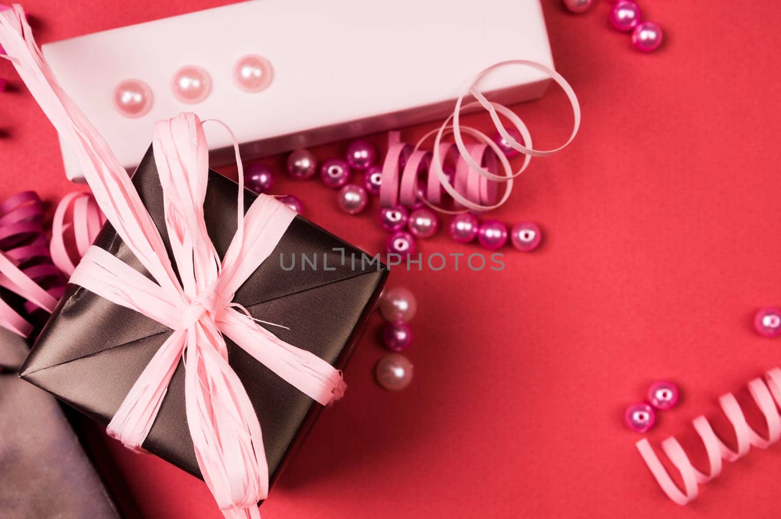 Set of gift boxes with bows, beads and ribbons on a colored background