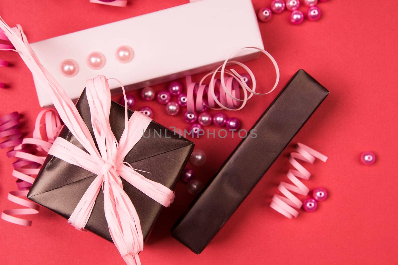 Set of gift boxes with bows, beads and ribbons on a colored background