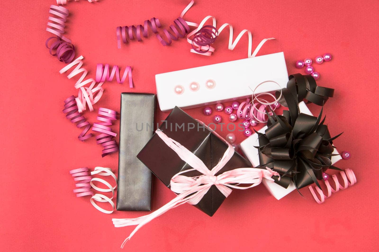 Set of gift boxes with bows, beads and ribbons on a colored background