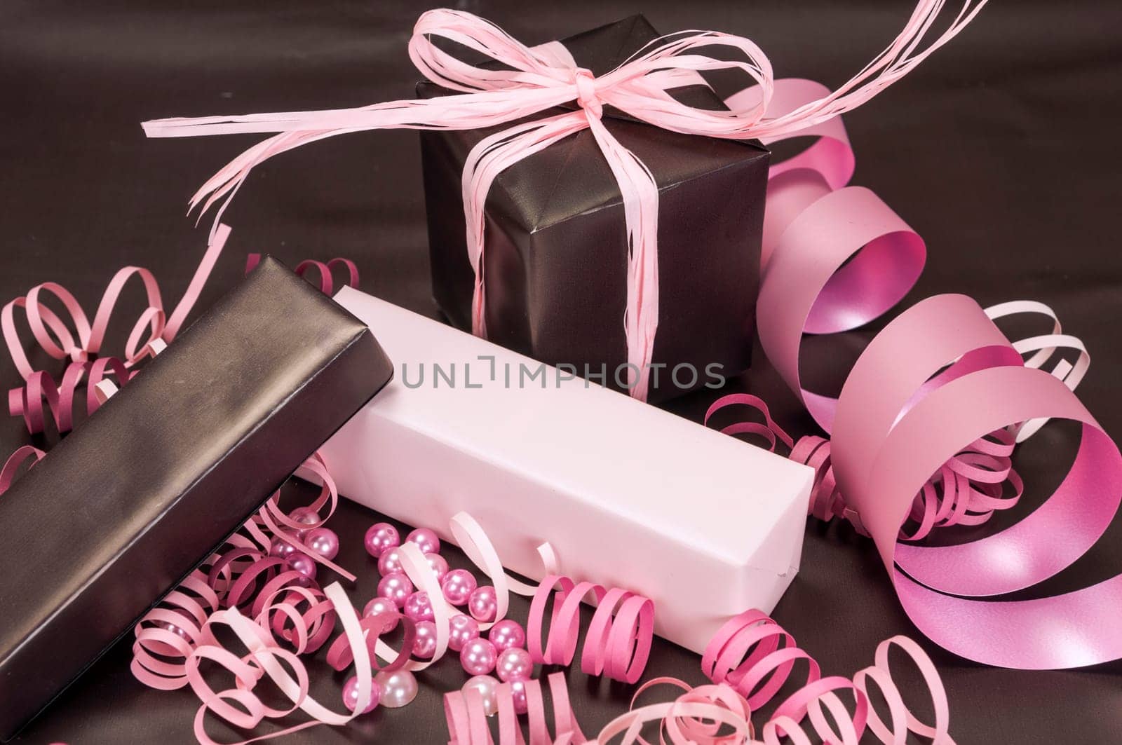 Set of gift boxes with bows, beads and ribbons on a colored background