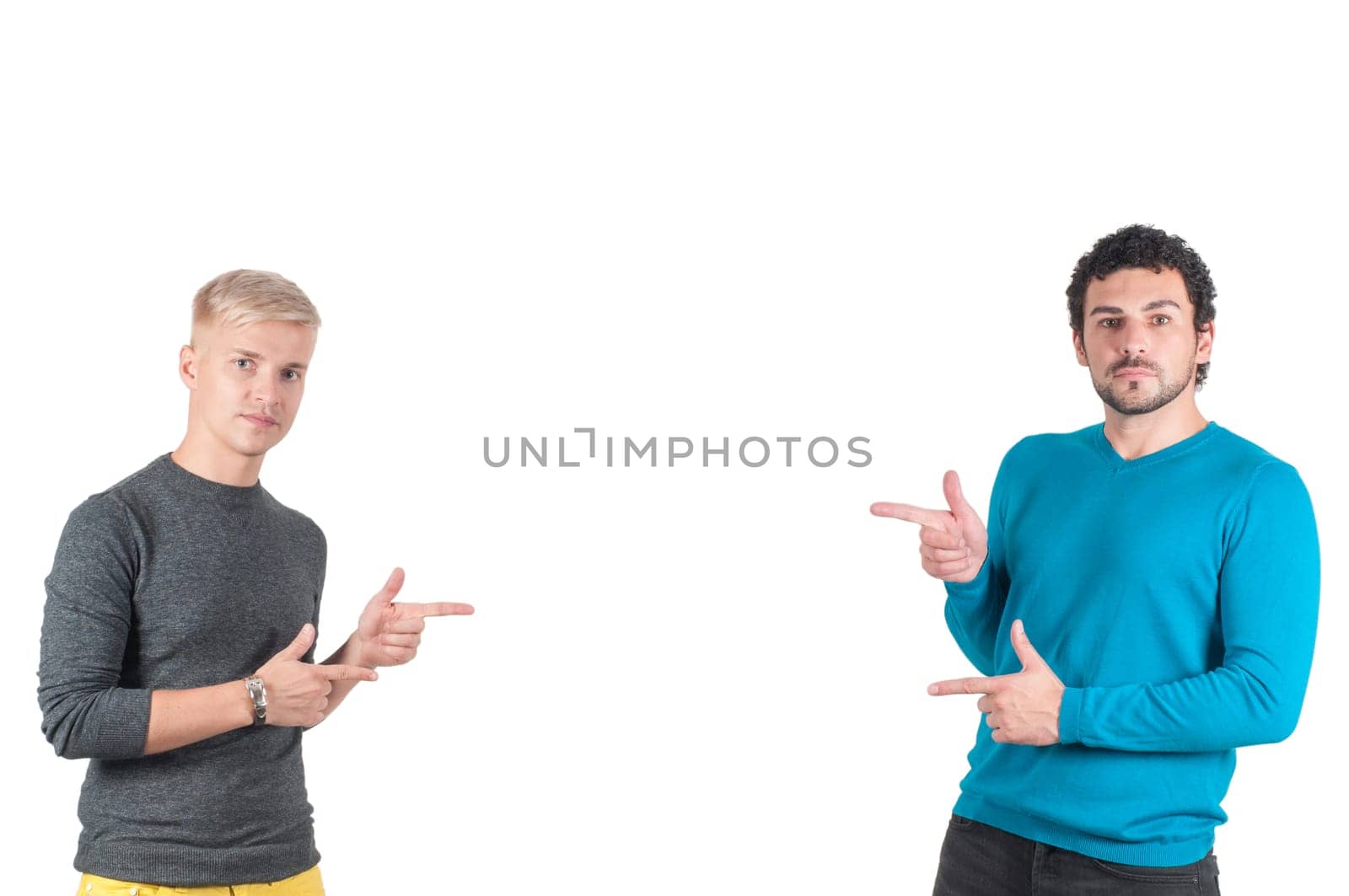 Two handsome guys showing somewhere with fingers, isolated on white