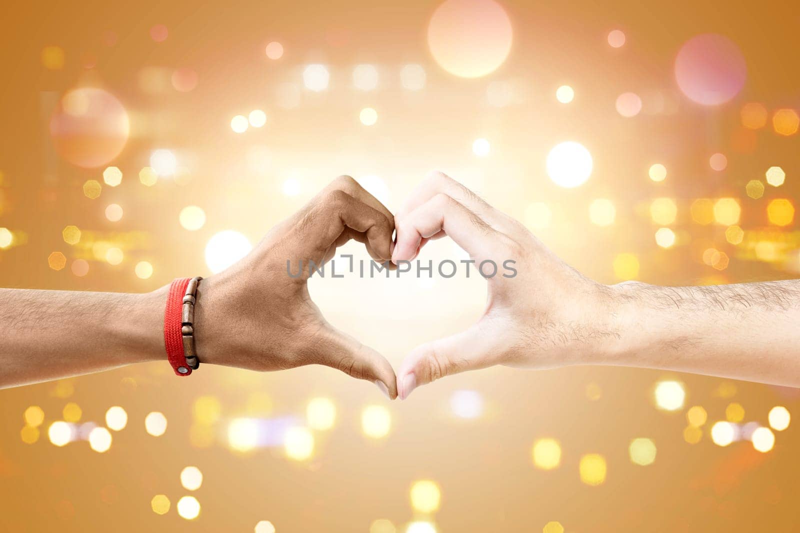 Couple of gay making a heart sign by hand with blurry lights background. LGBT concept