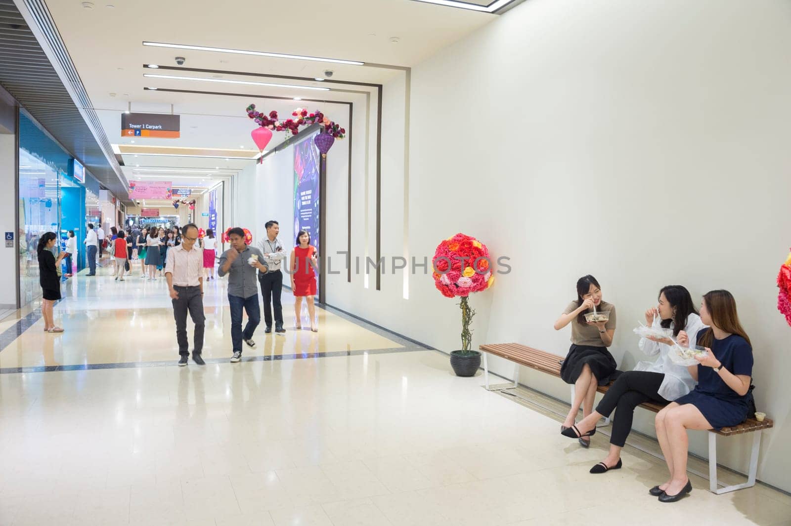 SINGAPORE - FEBRUARY 16, 2017: Women having a lunch on the beanch inside modern shopping mall in Singapore.