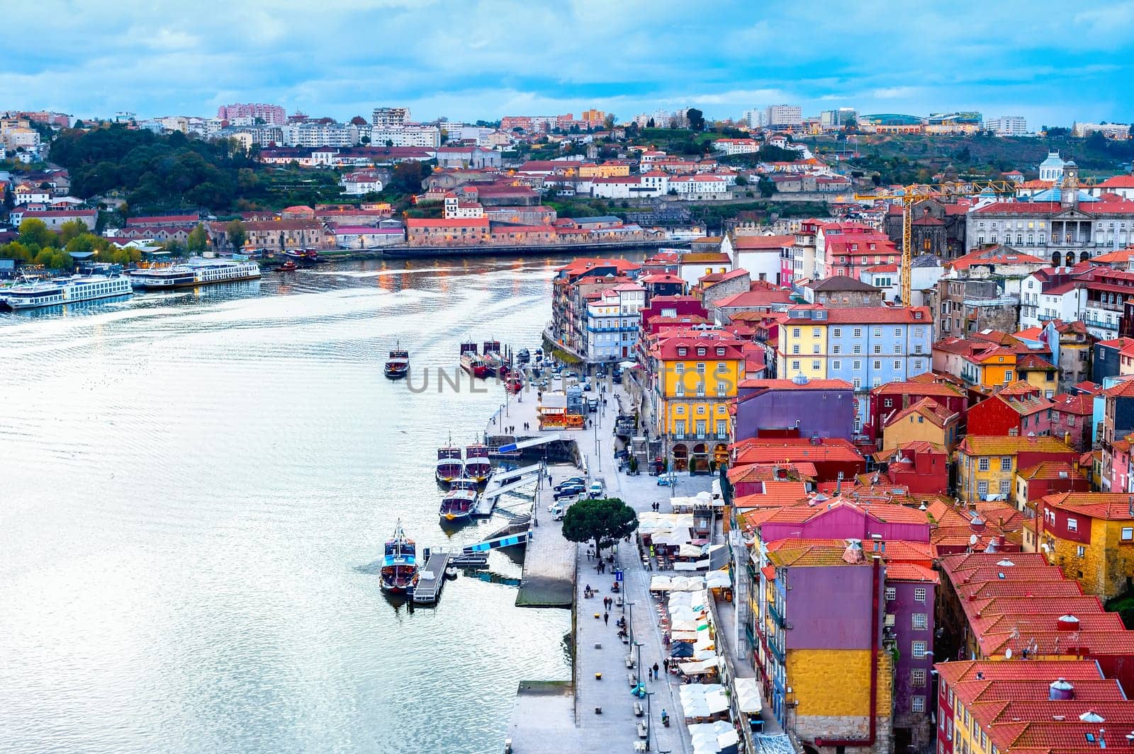 Porto aerial cityscape, old town embankment by Douro river with tourist boats . Portugal