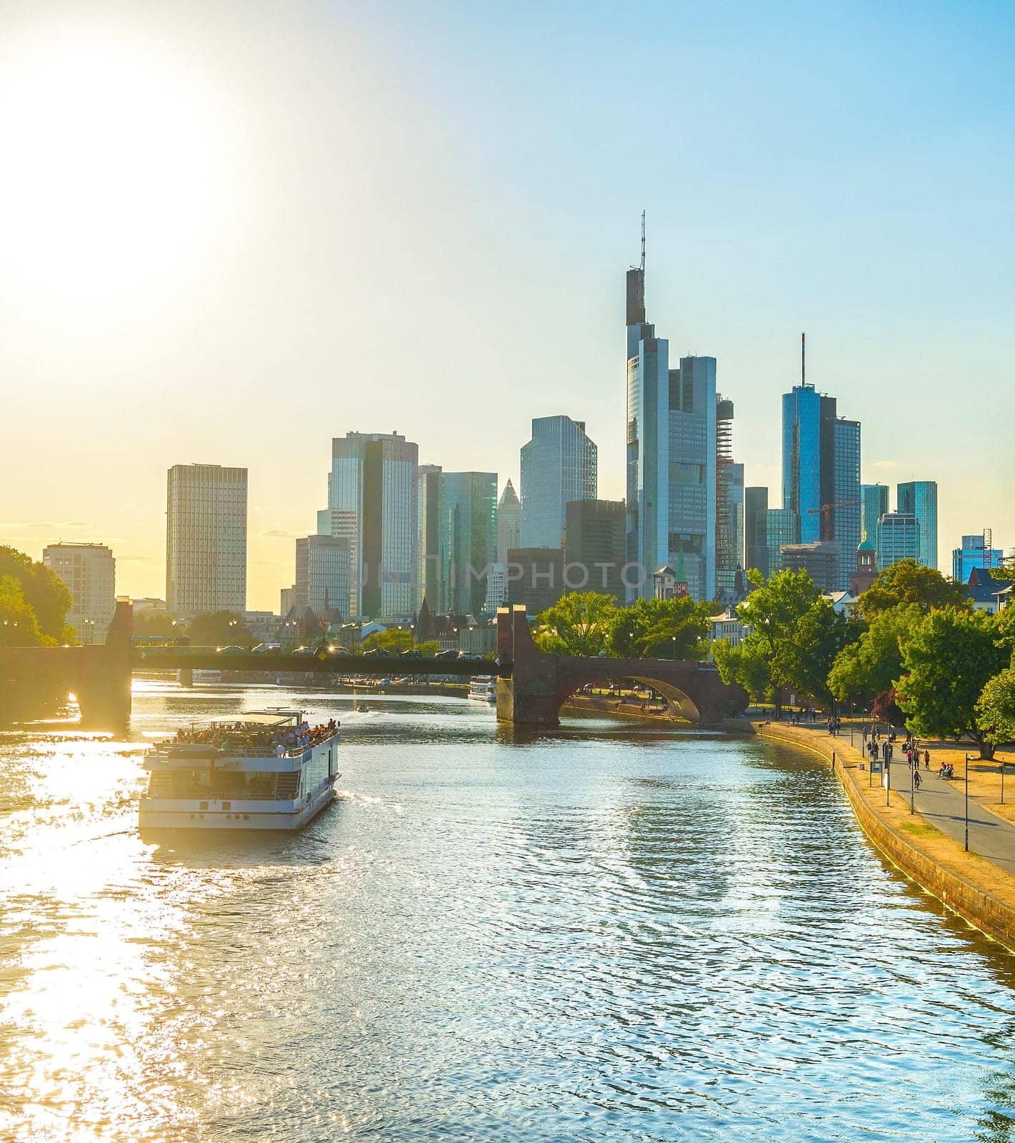 Touristic boat at Main river, view of Frankfurt Downtown, Germany