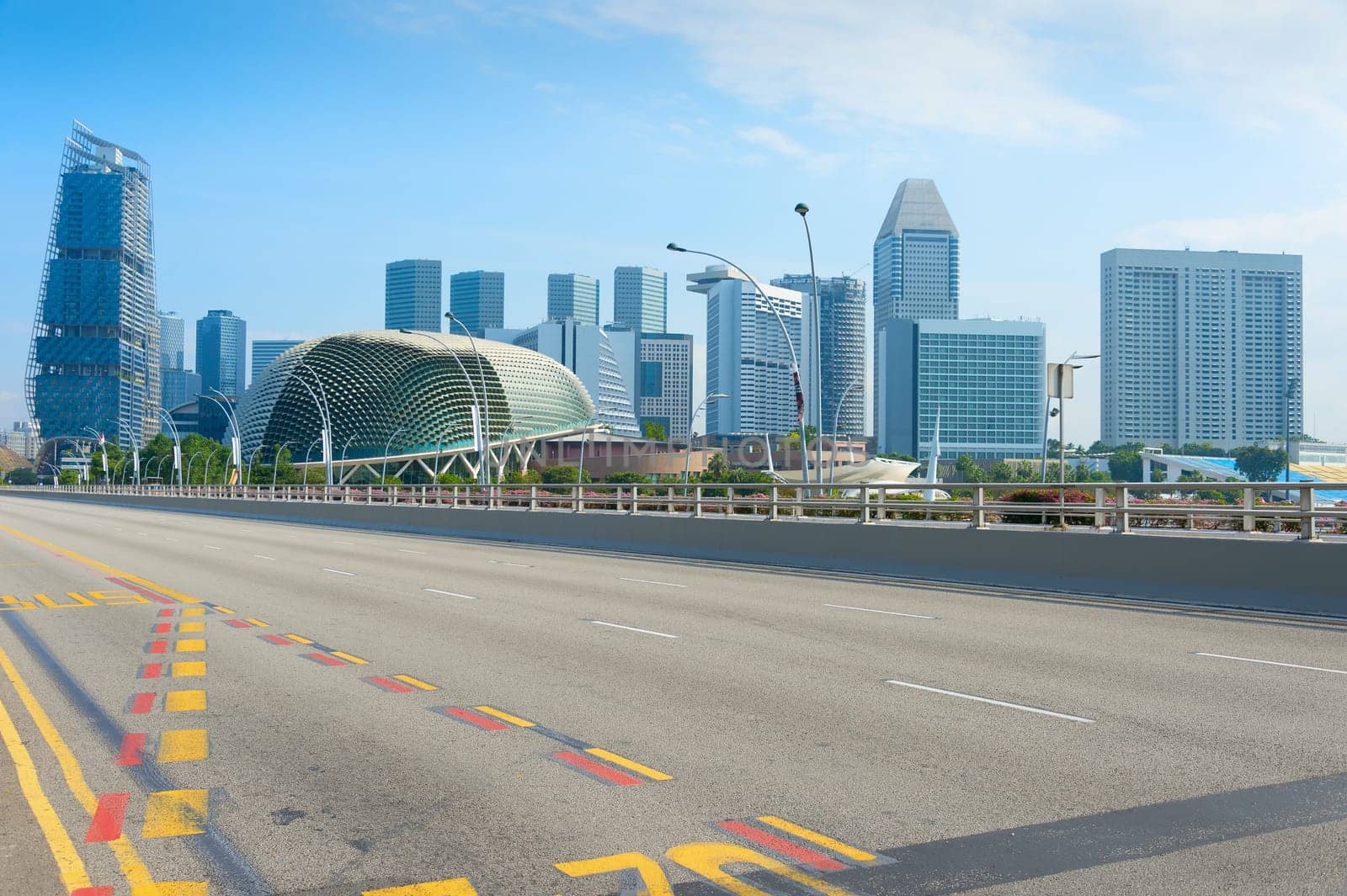Empty road, modern skyscrapers and Esplanade Theatres on the Bay in Singapore