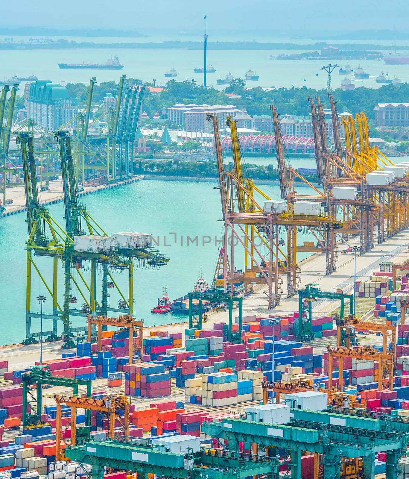 Aerial view of Singapore commercial port, stacks of shipping conteiners, freight cranes and cargo ships in harbor