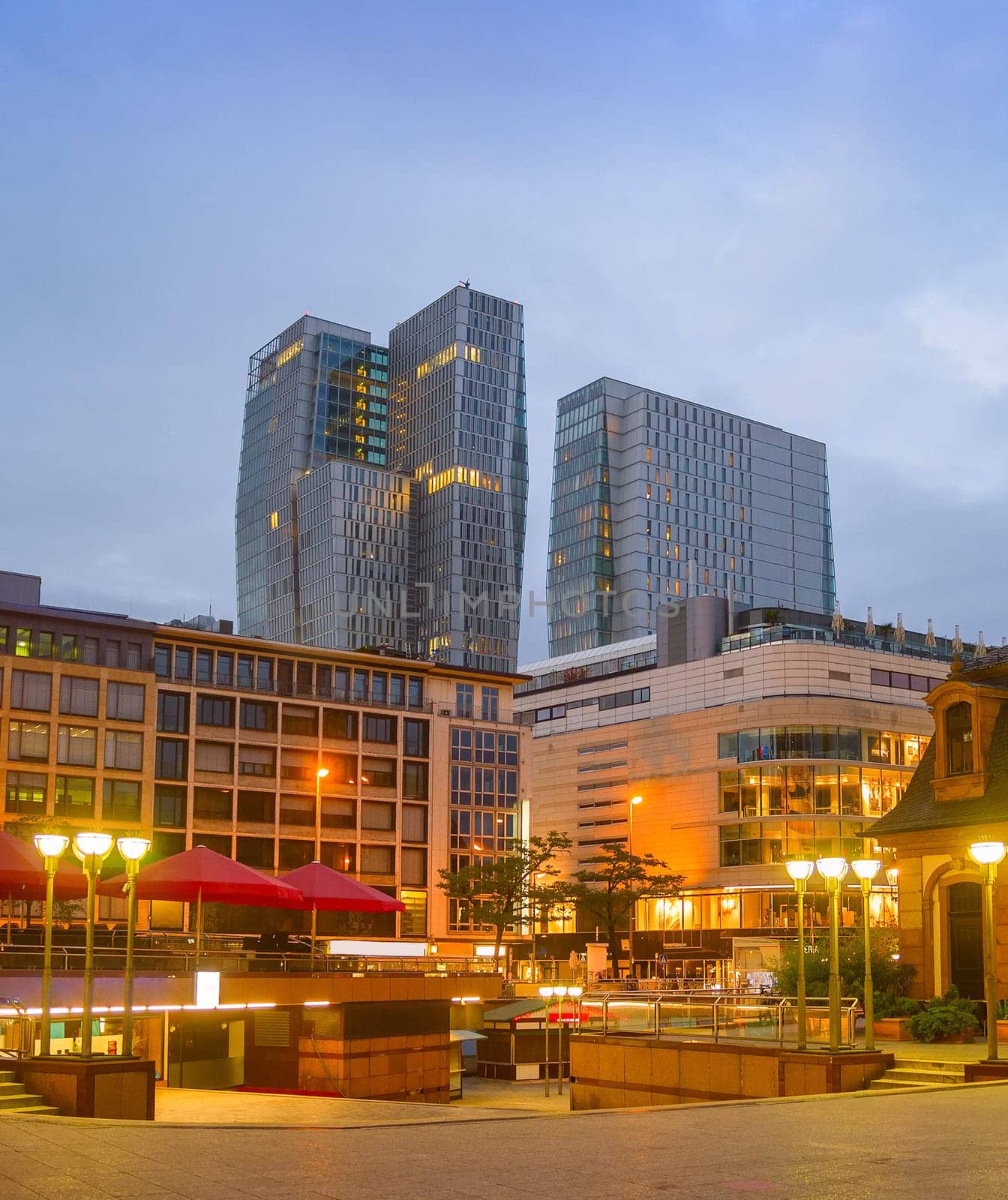 Evening cityscape of Frankfurt with illuminated downtown view, modern skyskrapers and restaurants, Frankfurt am main, Germany
