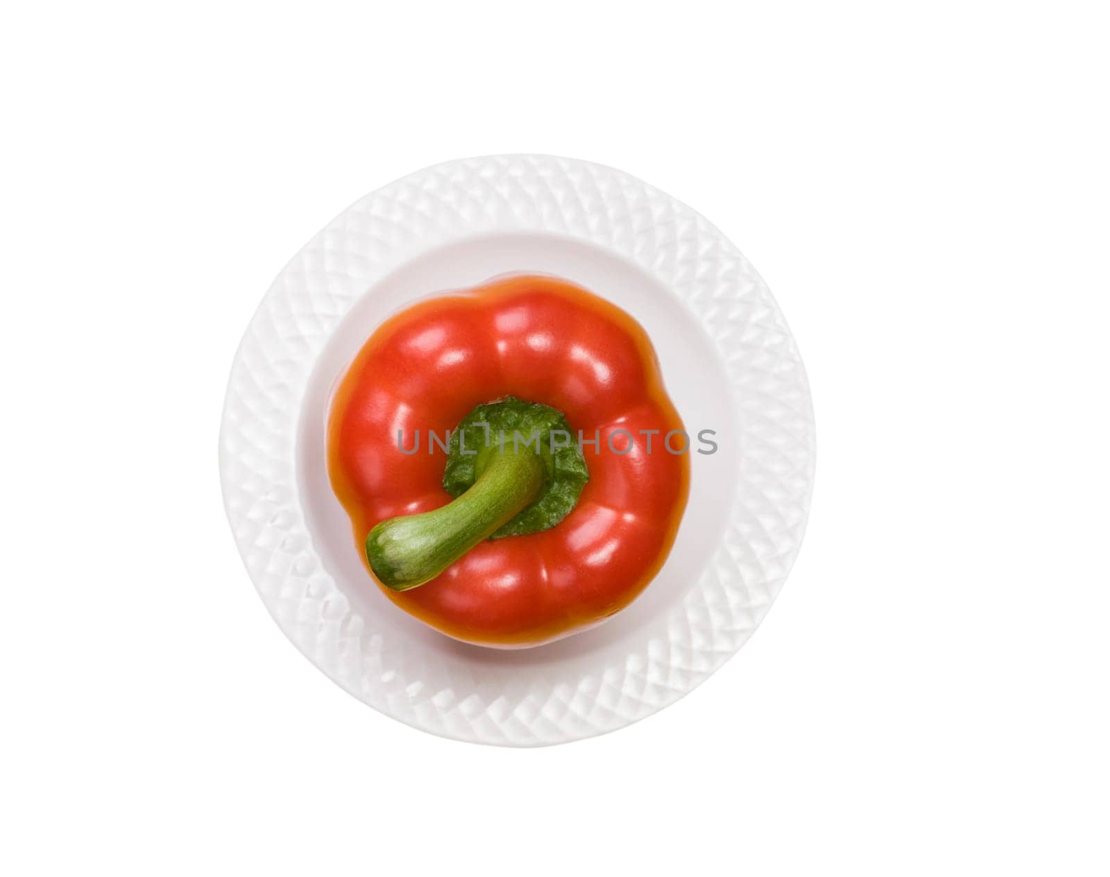 single red bell pepper on white plate isolated on white background