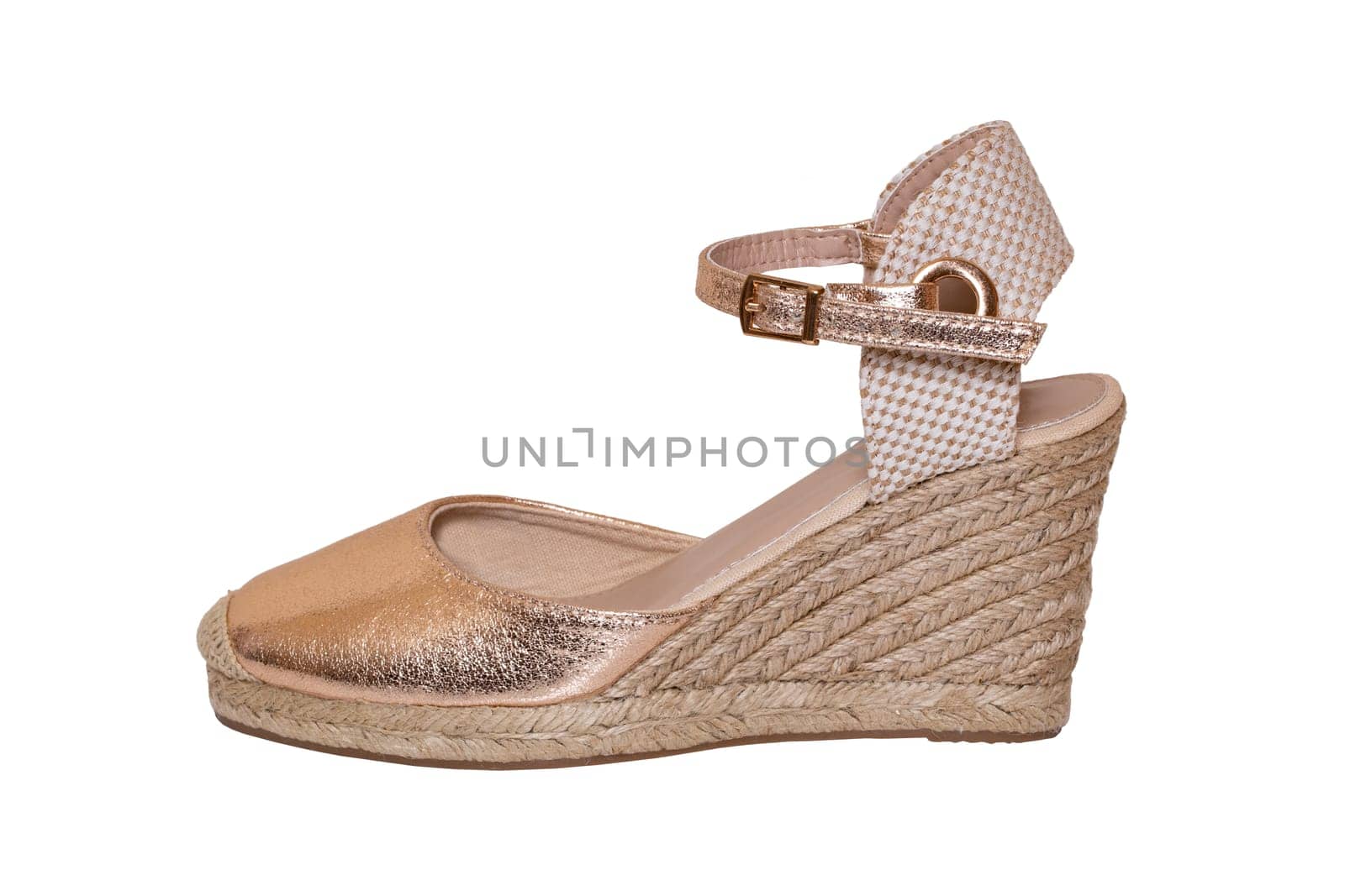 Golden shoes isolated. Closeup of a golden elegant female leather high-heeled shoe isolated on a white background. Womens shoe fashion 2019.