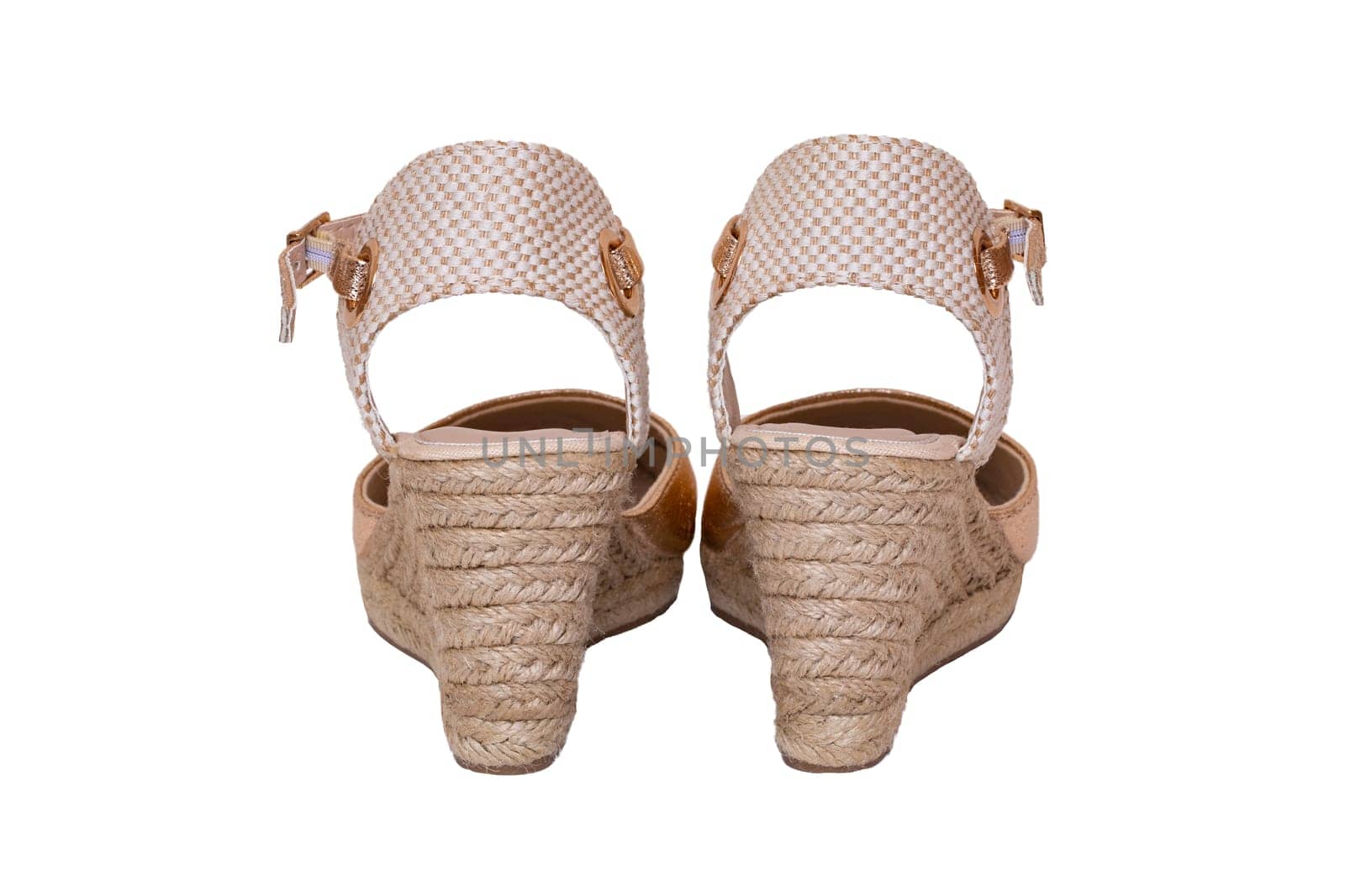 Golden shoes isolated. Closeup of a pair golden elegant female leather high-heeled shoes isolated on a white background. Womens shoe fashion 2019.