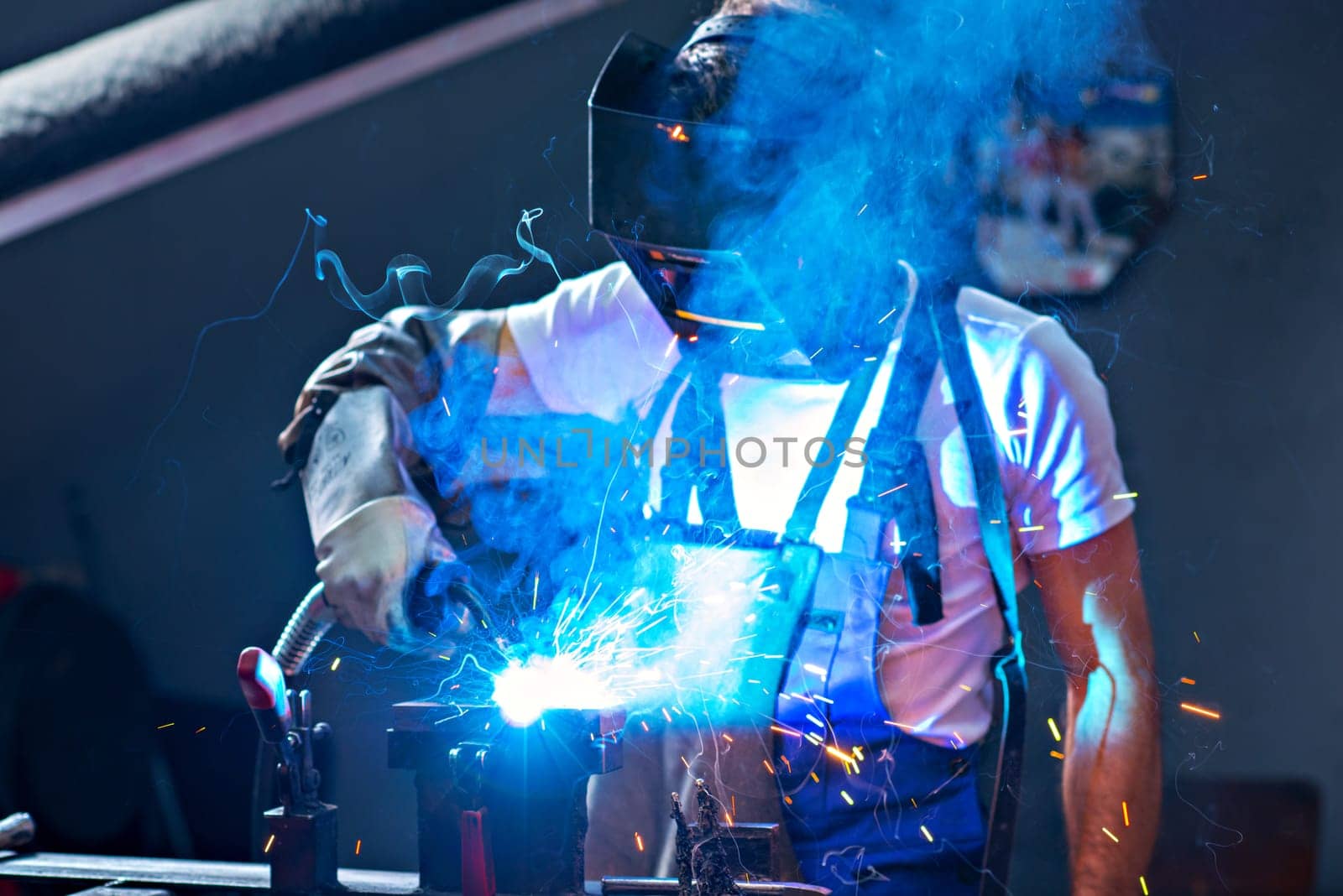 man welding metal in the factory