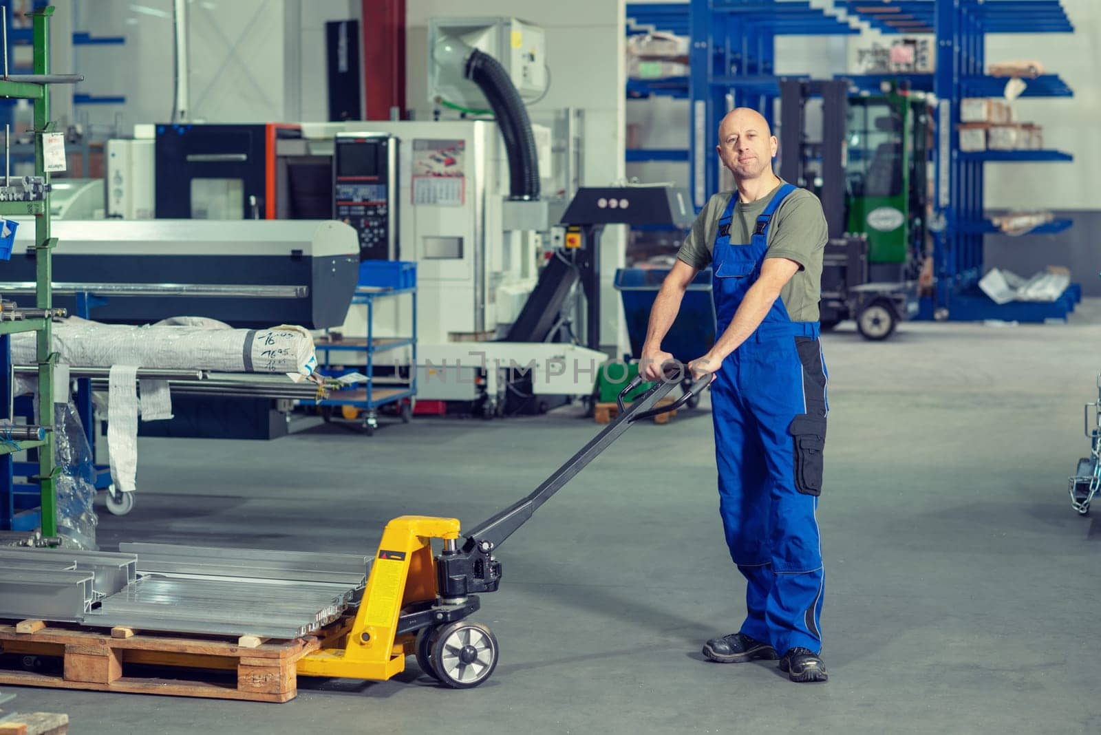 one worker in factory with hand lift
