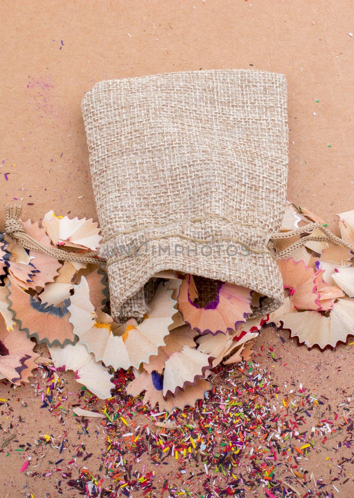 Colorful pencil shavings coming out of sack