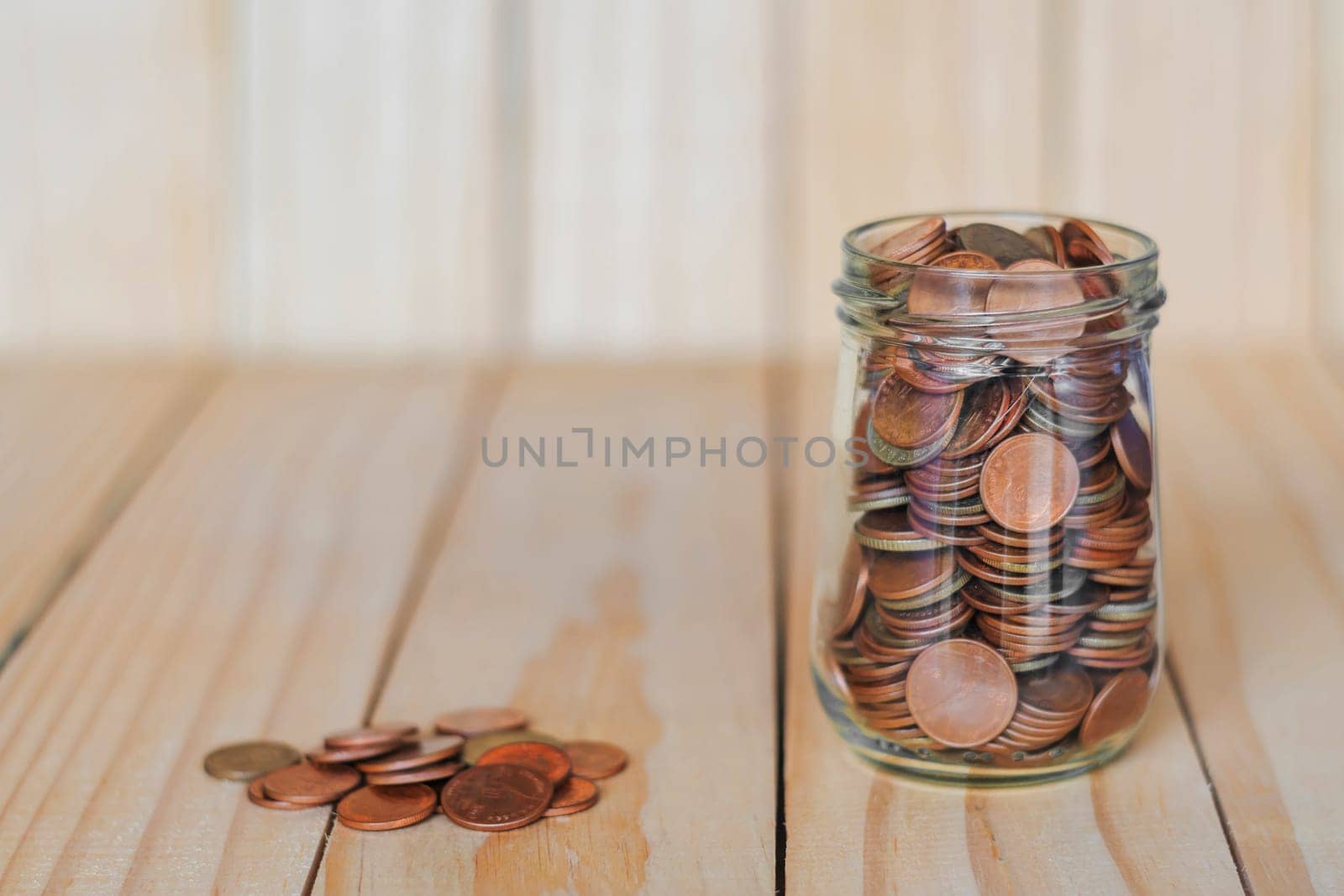 Save money and account banking for finance business concept, Coin money in bottle on business office table, Savings for retirement and investing concept