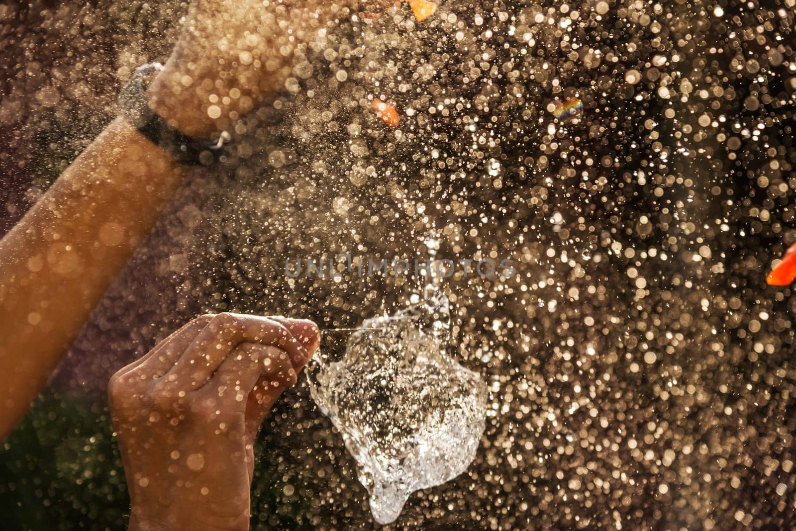 Hand of girl with water splash on black background dark filter style