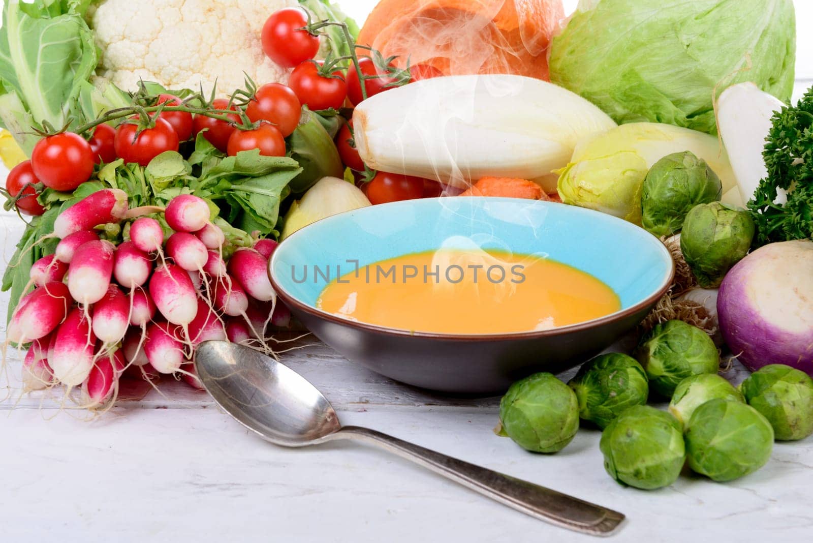 plate of pumpkin soup with  several vegetables