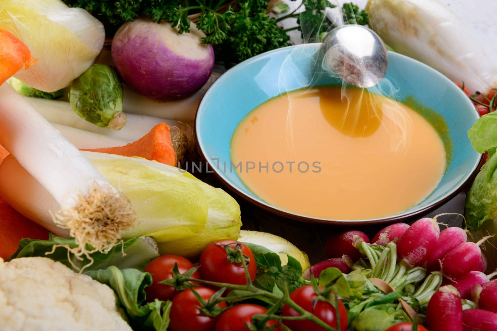 plate of pumpkin soup with  several vegetables