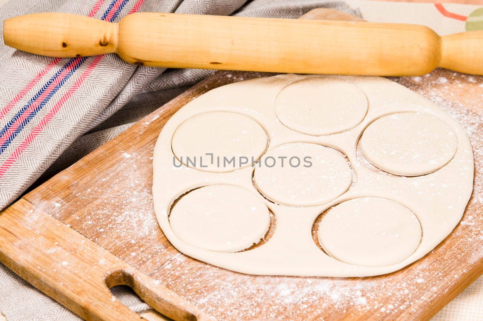 fresh raw dough and rolling pin for baking