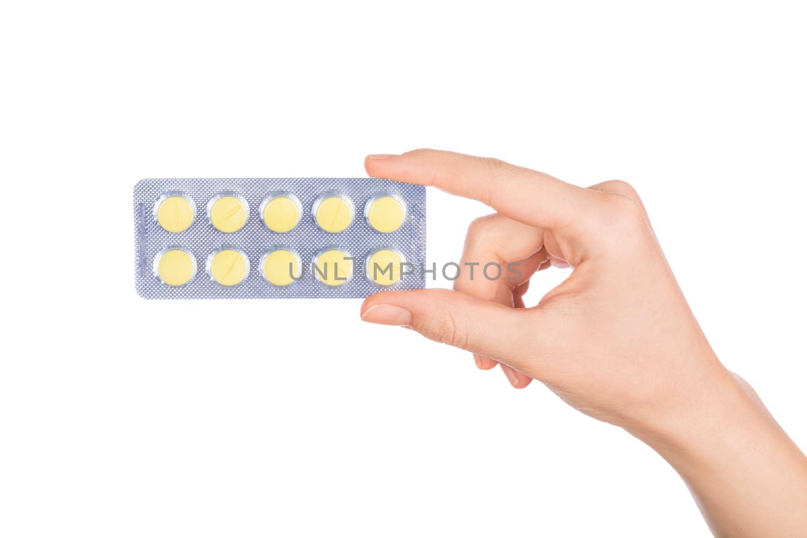 Woman hand holding pills tablet. Female hand holding prescription pill over white background.